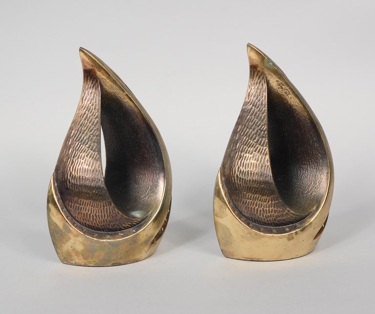Sculptural flame brass plate bookends designed by Ben Seibel. These were part of the Jenfred Ware line by Raymor. These show a little wear and have some oxidation in a few spots.