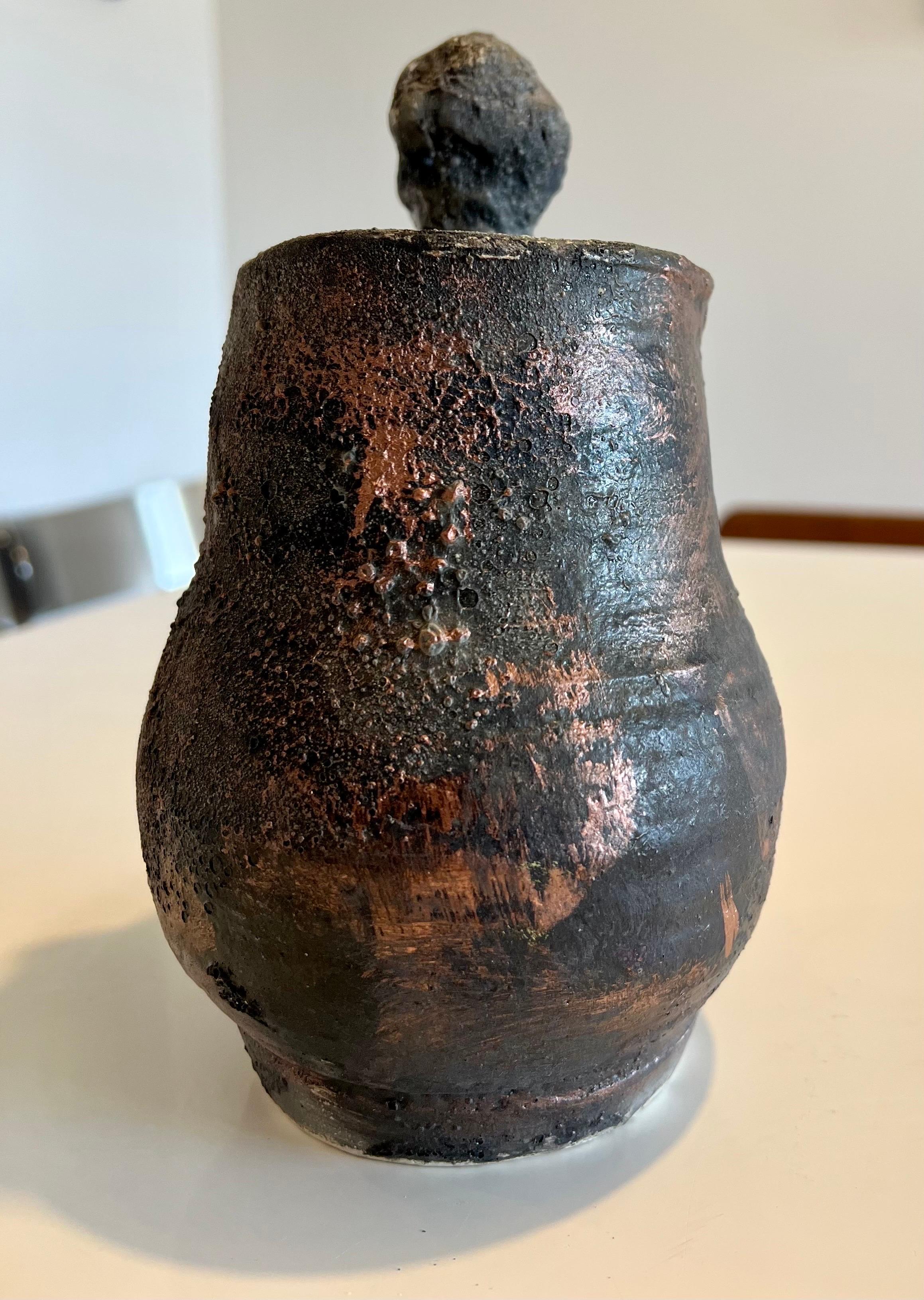 Jenik Cook
Handmade ceramic vase or pot sculpture 
Hand signed by the artist.
Fired clay with a luster bronze painted finish 

Jenik Esterm Simonian Cook is a painter and ceramicist sculptor in the tradition of such visual theorists as Arshile