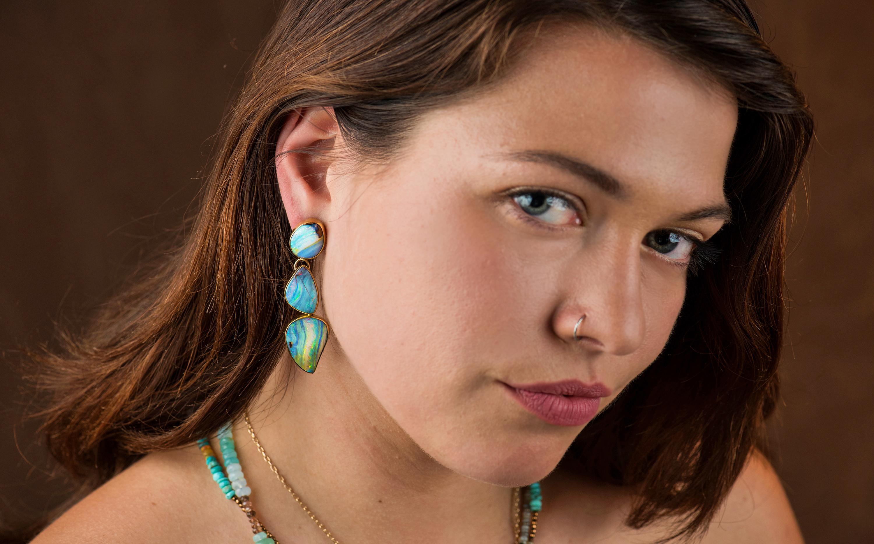 If you love mismatched earrings, these boulder opal earrings are lovely!  The many hue's of blue, green and orange is striking agains't the high karat gold.