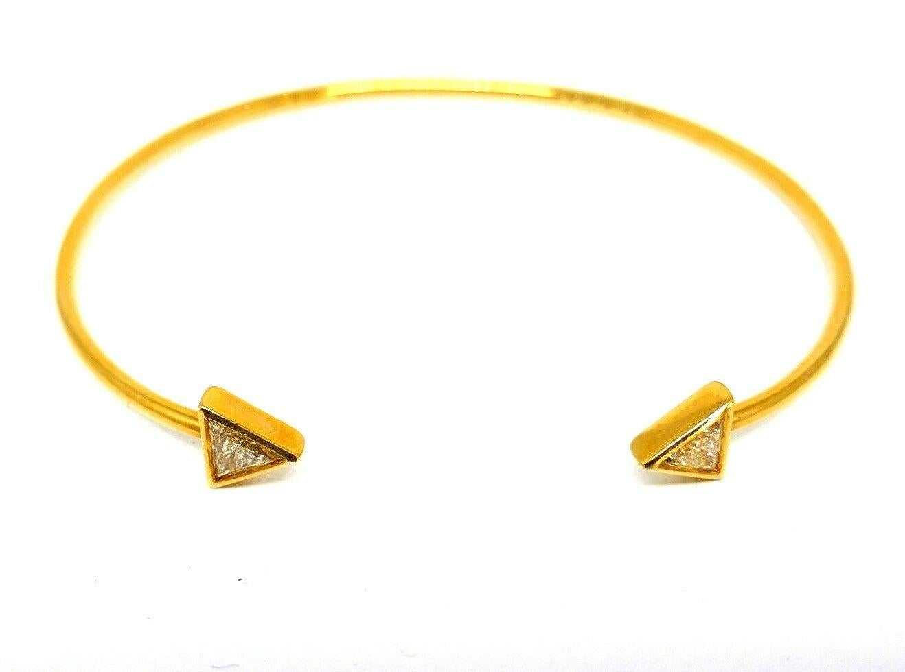 Delicate wire bracelet made of 18k yellow gold, signed by Jennifer Meyer. Narrow ends accentuated with trillion cut diamonds.  Carat weight is about 0.40 points each. 
Stamped with Jennifer Mayer maker's mark and a hallmark for 18k