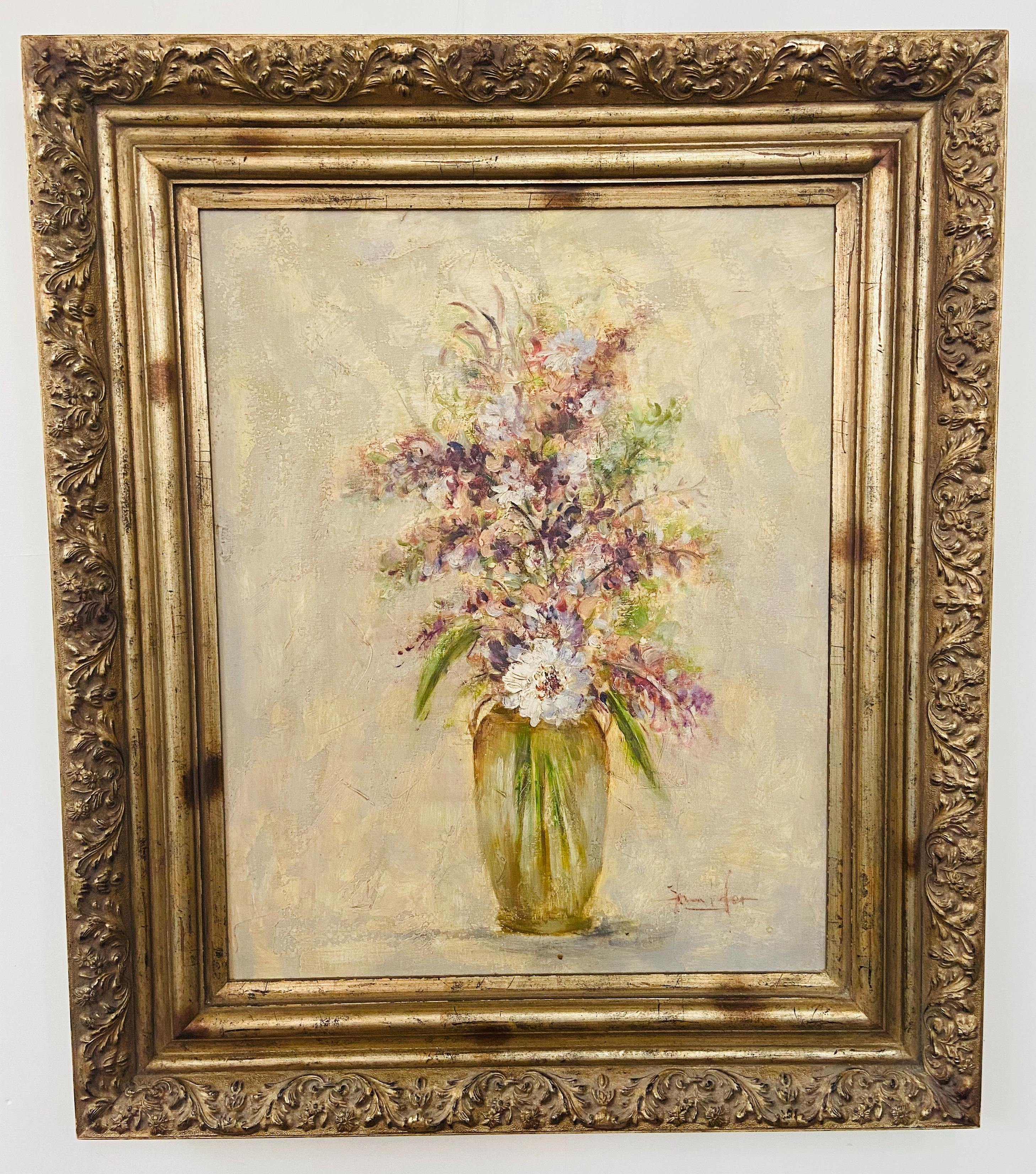 A gorgeous oil on canvas painting in a pastel tone depicting a vase with white flowers and lavenders in a vase. The painting is beautifully framed in a custom gilt carved wood frame and is signed by artist Jennifer. 

Dimensions: 40.5