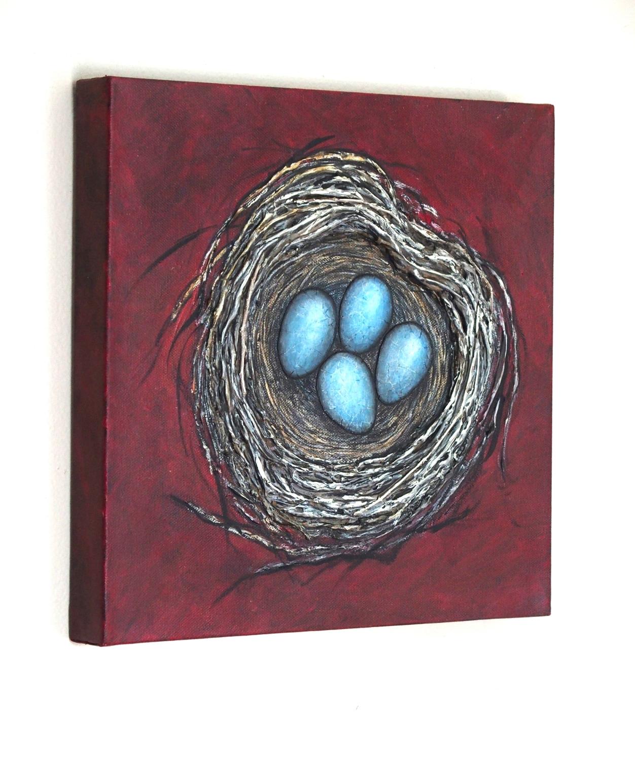 <p>Commentaires de l'artiste<br />Un nid en forme de cœur réalisé avec du gel acrylique et des brindilles crée un effet texturé et organique. Les quatre délicats œufs bleus, formés par des collages de coquilles d'œufs, contrastent avec les tons