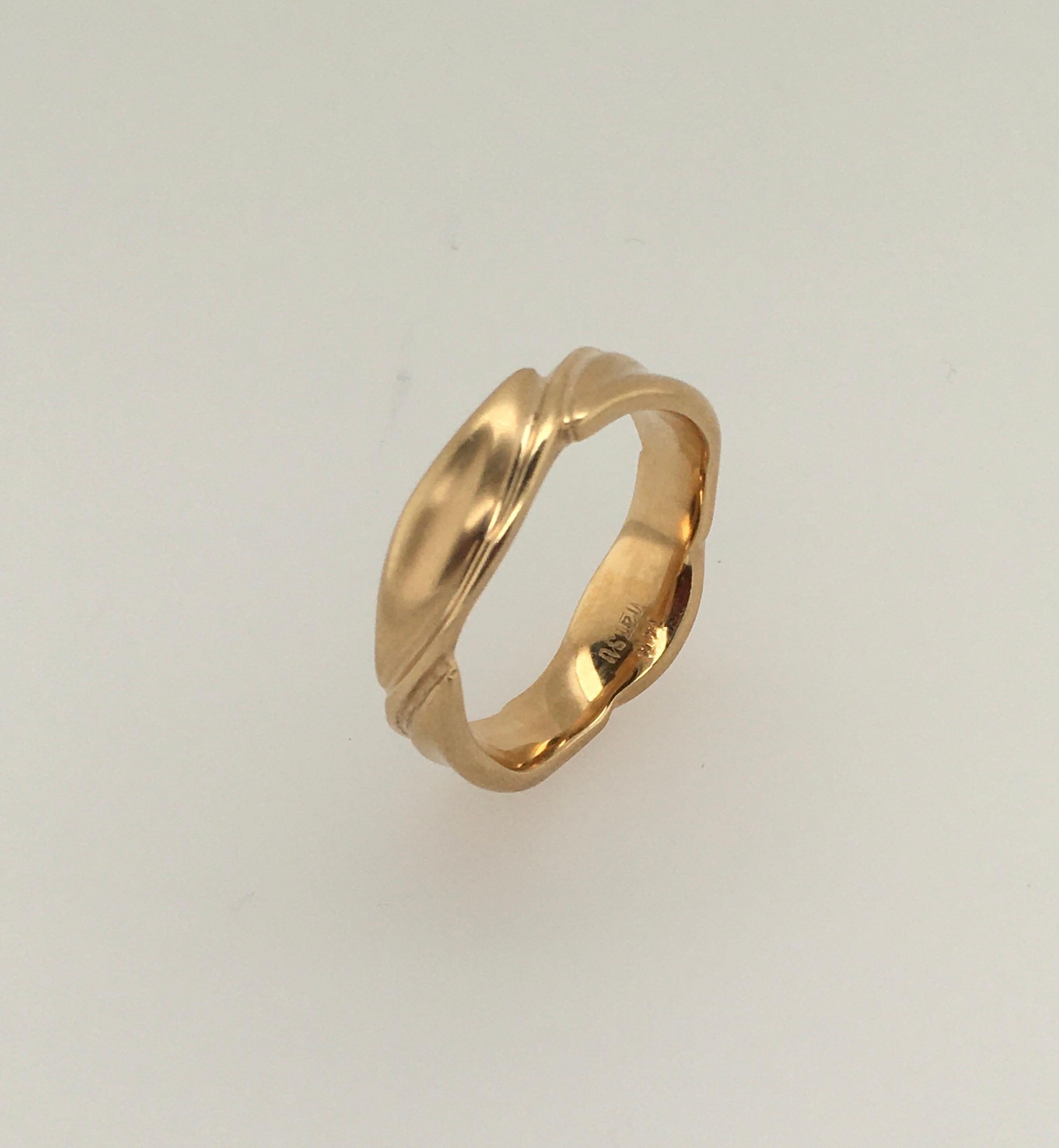 This sophisticated one-of-a-kind Guinevere wedding band features a stylized leaf and vine motif created in 14K yellow gold. The ring is enhanced with a dramatic satin finish with polished accents.  The width is approximately 5.8-6.0 mm. Makers mark