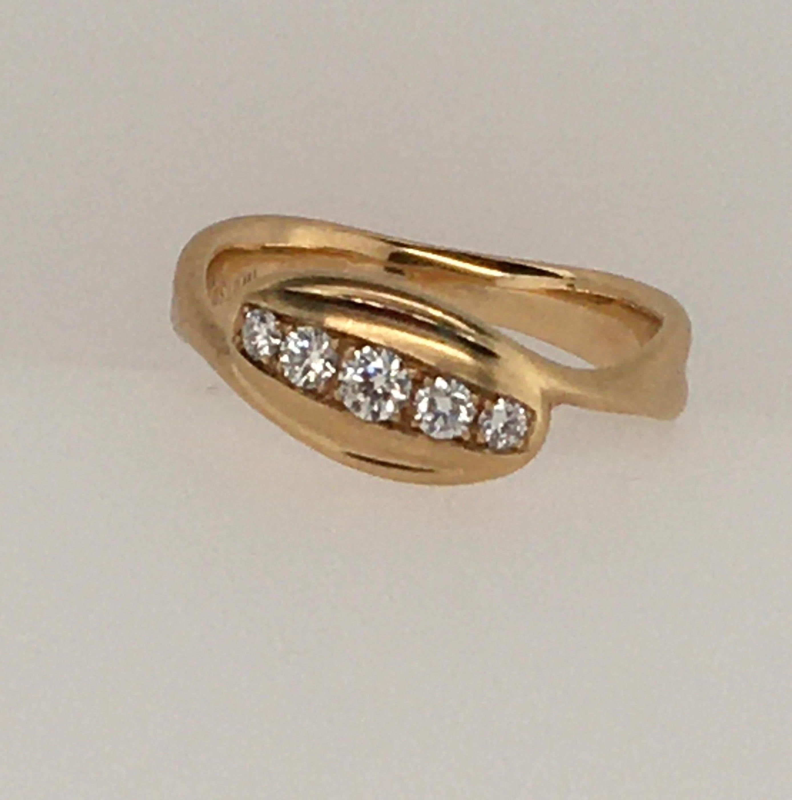A beautiful example of Jennifer Shigetomi's distinctive style, this 14K yellow gold stylized satin finish ring features 5 embedded diamonds with a TCW of .22.   F, G Color , Vs1.    Interior imprint reads 
