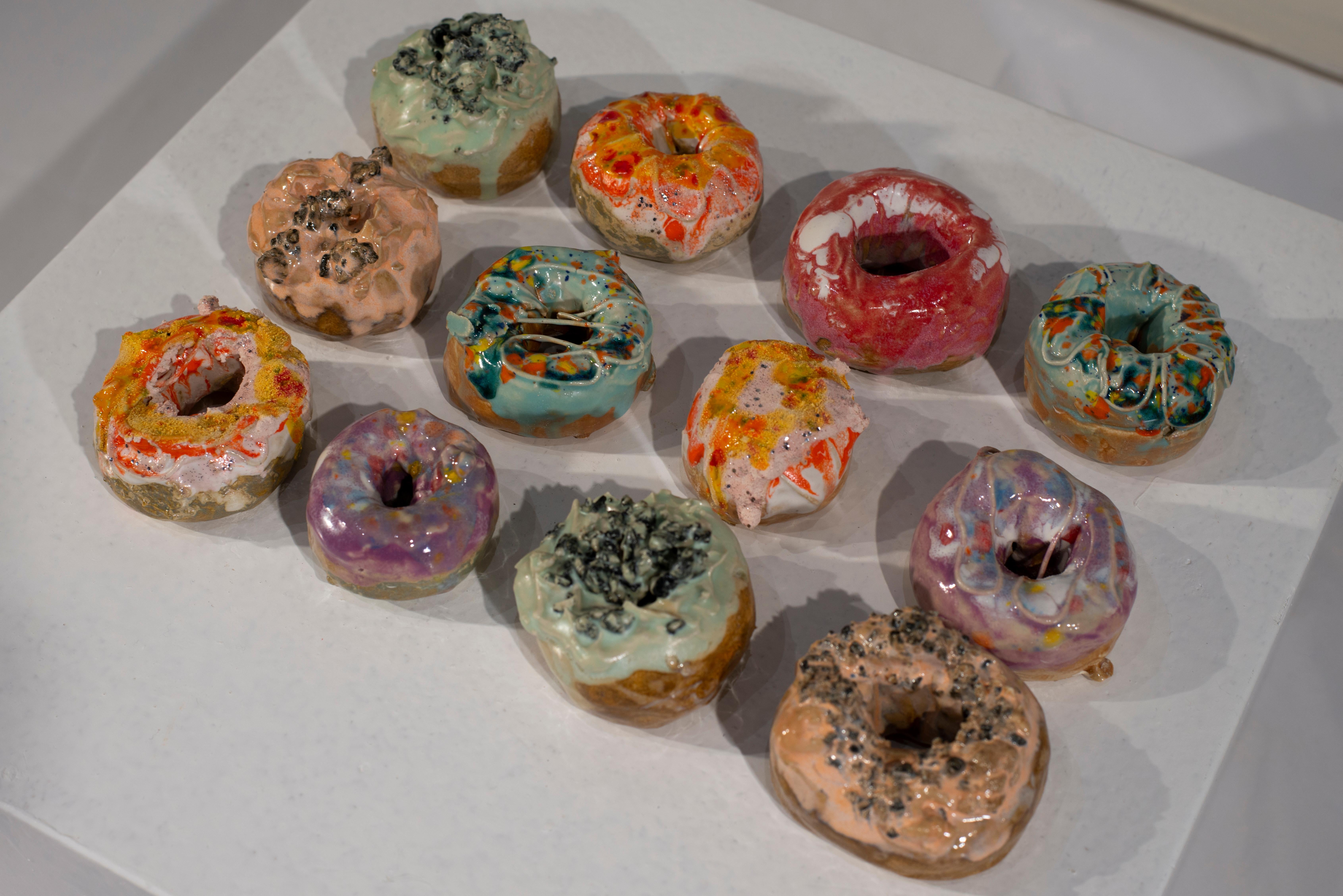 Multiple of 12, 6 currently available: Red & white; Pink, yellow, red, with swirl; Light blue & rainbow, with swirl & triangular hole; Small purple; Peach colored, line of toppings; Seafoam green, blue toppings. $125 per piece.

JENNY DAY earned an