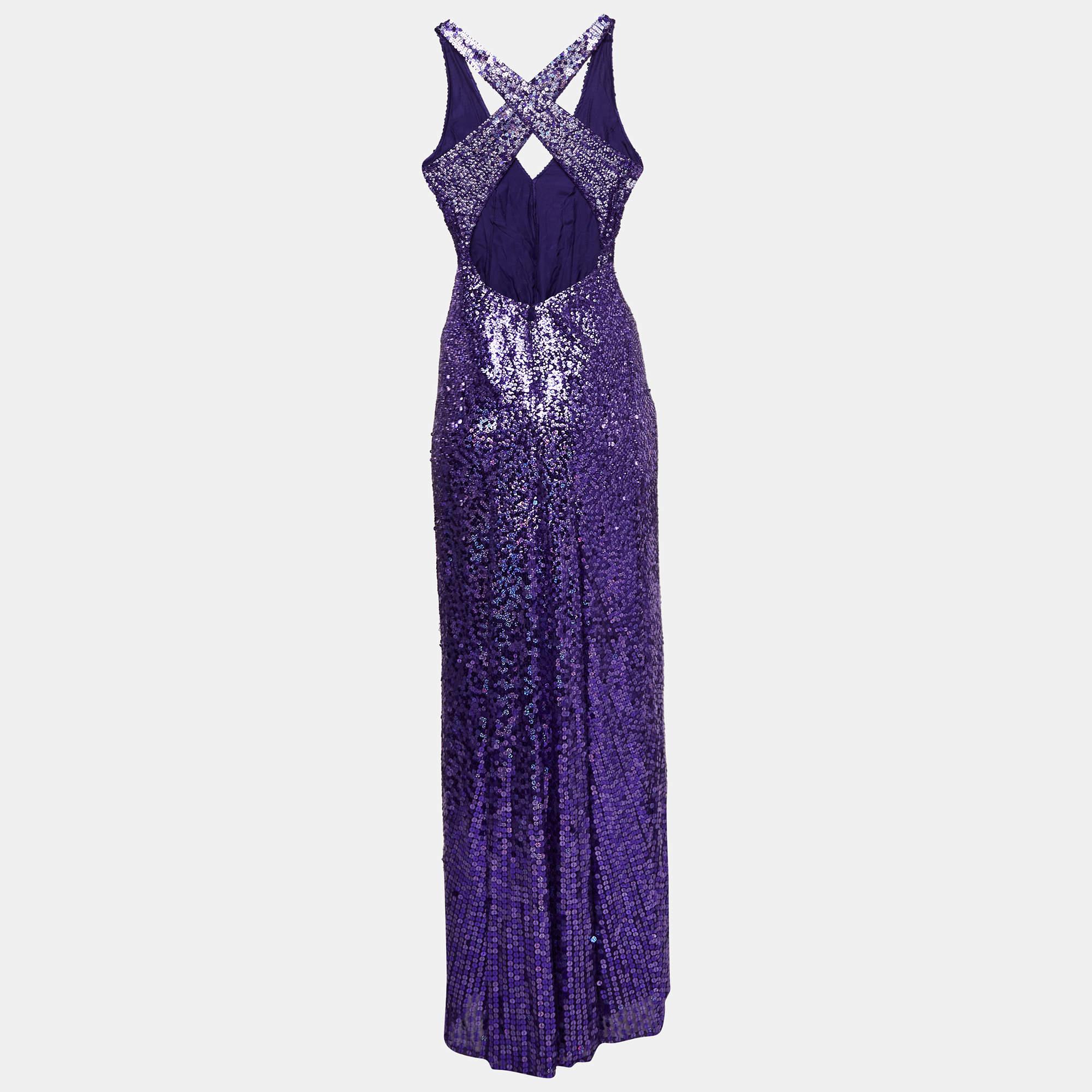 Part of the Fall/Winter 2010 collection  this Jenny Packham dress is an embellished paradise. Its shimmery exterior is decoratedÂ with purple sequins. The waist is accentuated with ruching  combined with the deep halter neck and an open cross back.

