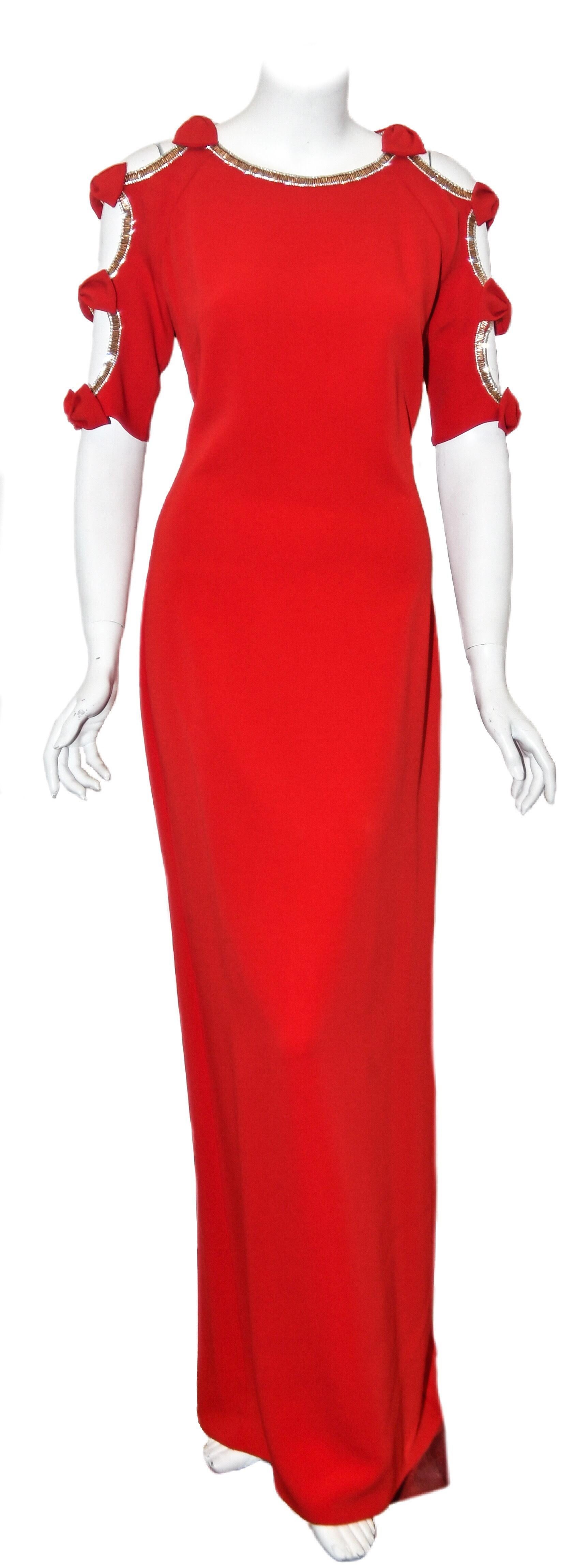 Jenny Packham can almost be classified as the official designer of the royals. This designer has unique and exceptional gowns for all occasions.  This red cold shoulder long evening dress has a beaded trim around neckline, shoulders and sleeves. The