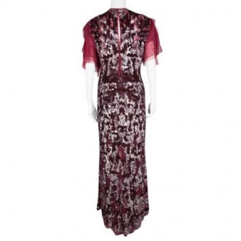You won't bee able to draw yourself away from the mirror once you put this ravishing Jenny Packham dress on. In a fierce red shade, the dress is covered in sequins and designed with a V neckline and ruffled sleeves. The creation is glamorous and
