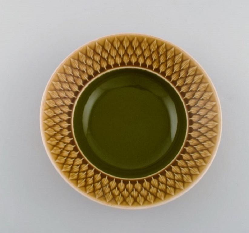 Jens H. Quistgaard (1919-2008) for Bing & Grøndahl. 
Five Relief deep plates in glazed stoneware. Beautiful glaze in mustard yellow and green shades. 1960s.
Measures: 21.5 x 6 cm.
In excellent condition.
Stamped.
