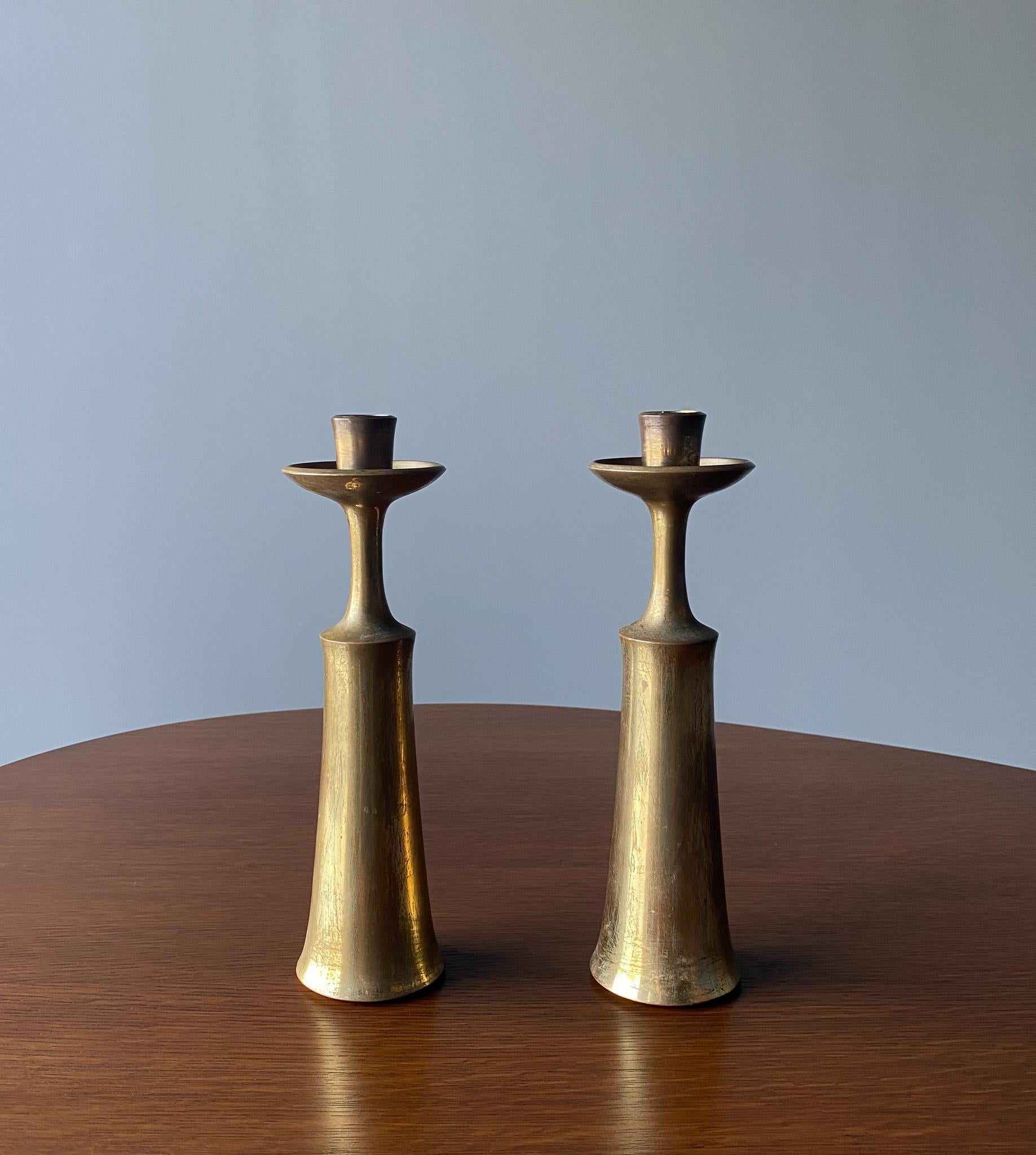 Jens H. Quistgaard Brass Candlesticks for Dansk Designs, Denmark, 1960s.  Nice original patina.  Each signed with makers mark to the bottom. 
