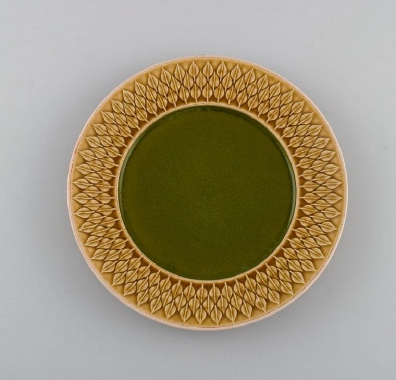 Jens H. Quistgaard (1919-2008) for Bing & Grøndahl / Nissen Kronjyden. 
10 Relief lunch plates in glazed stoneware. Beautiful glaze in mustard yellow and green shades. 1960s.
Diameter: 21 cm.
In excellent condition.
Stamped.