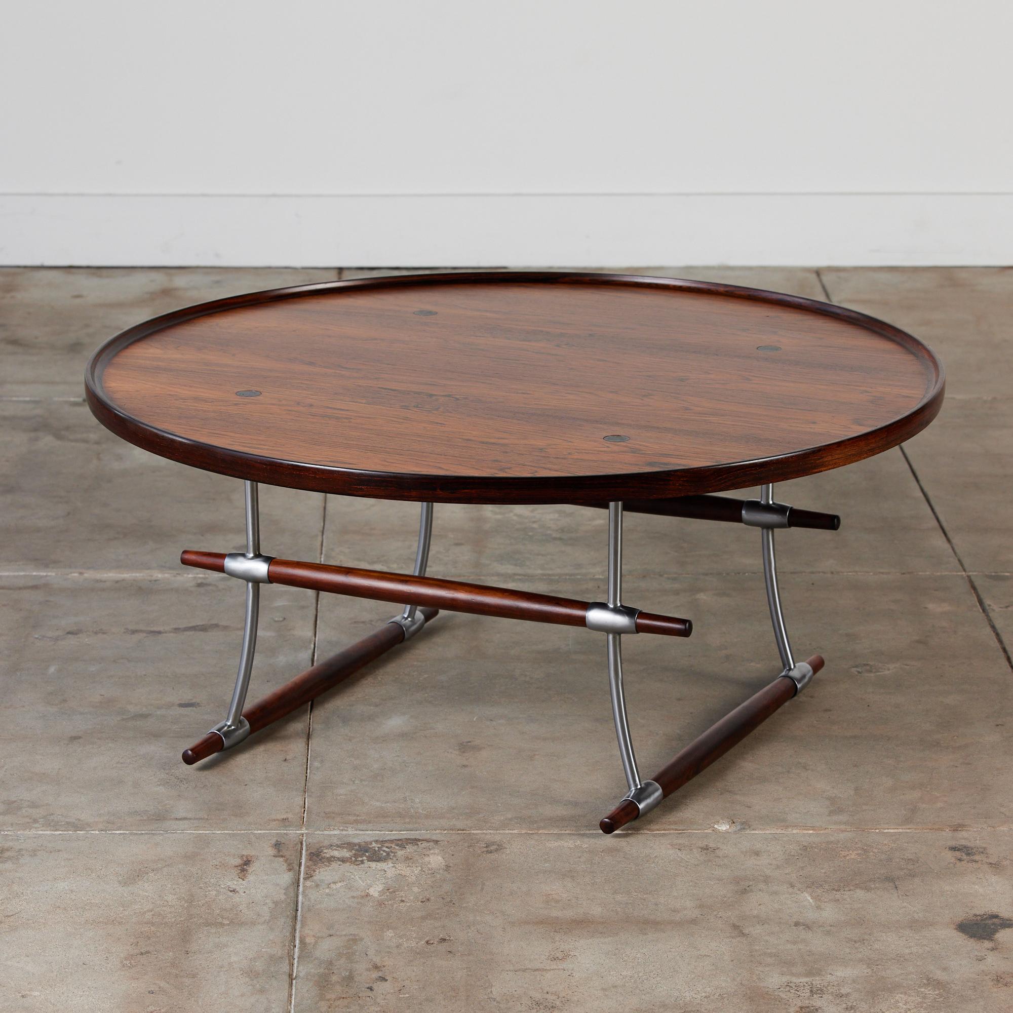 This coffee table by Jens H. Quistgaard for Nissen, c.1960s Denmark features a hand-oiled table top and frame composed of rich rosewood chrome plated steel. The table top has a raised edge around the perimeter. This table would pair perfectly with