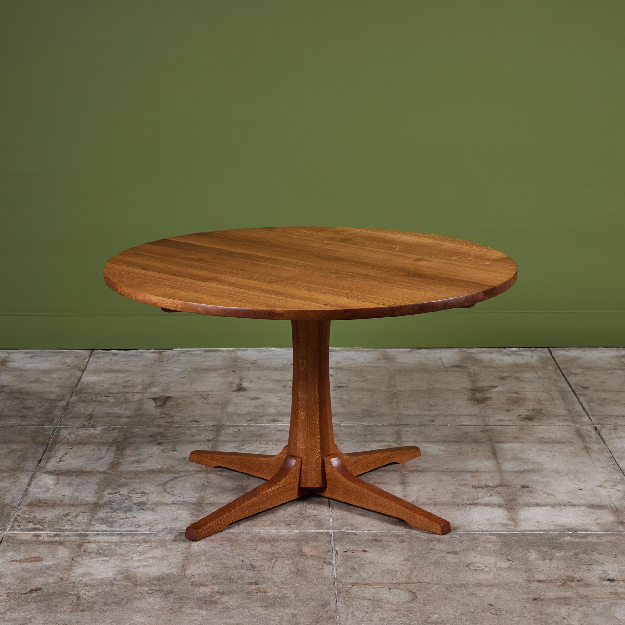 Dining table by Jens H. Quistgaard for Nissen, c.1960s Denmark features a hand-oiled round table top and pedestal base all comprised of solid oak. The table can comfortably seat four to six.

Dimensions 
47