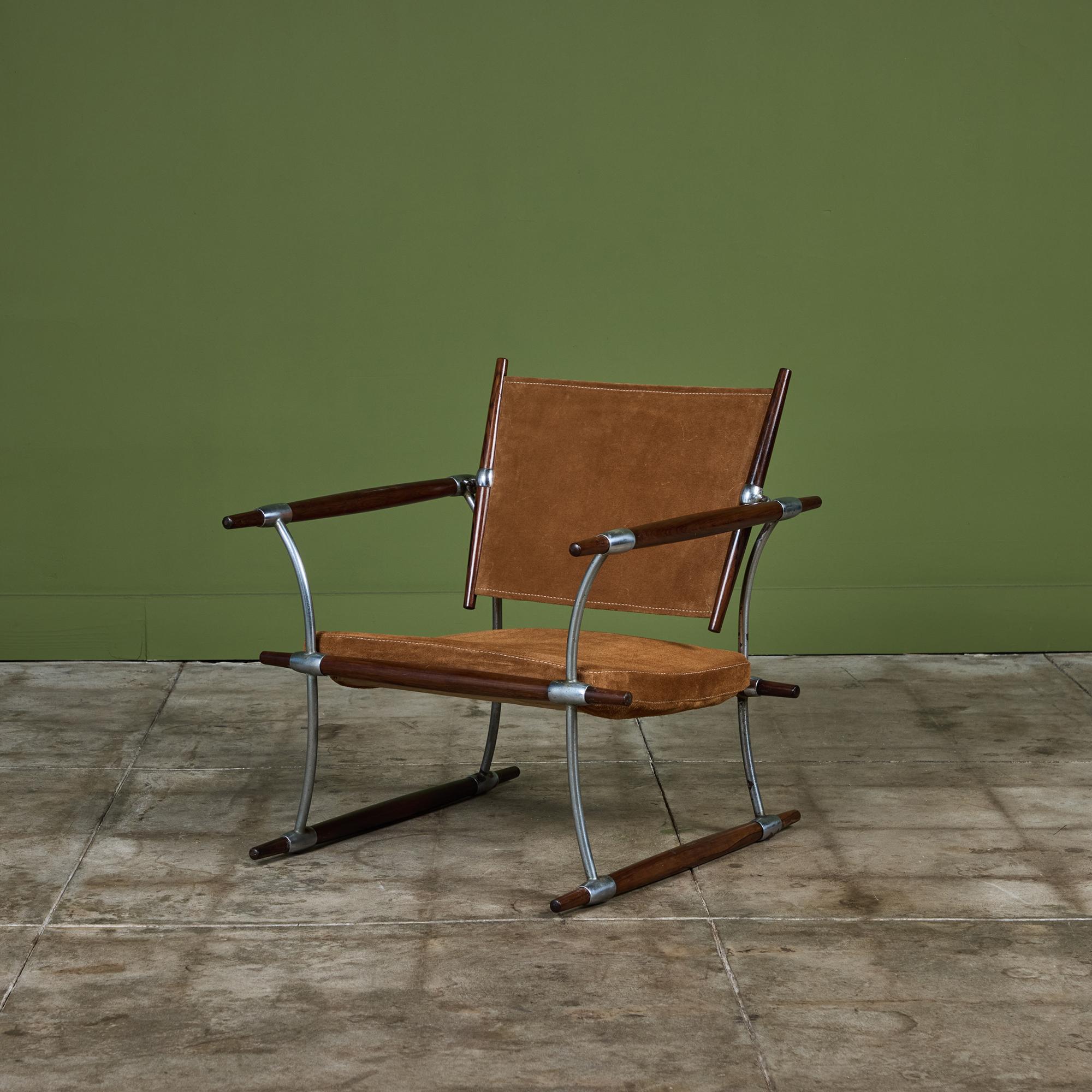 'Stokke' lounge chair by Jens H. Quistgaard for Nissen, c.1960s Denmark. The sling backrest and seat cushion features a new dark tan suede. The frame of the chair is composed of rich toned Rosewood dowels and chrome plated steel, a gorgeous
