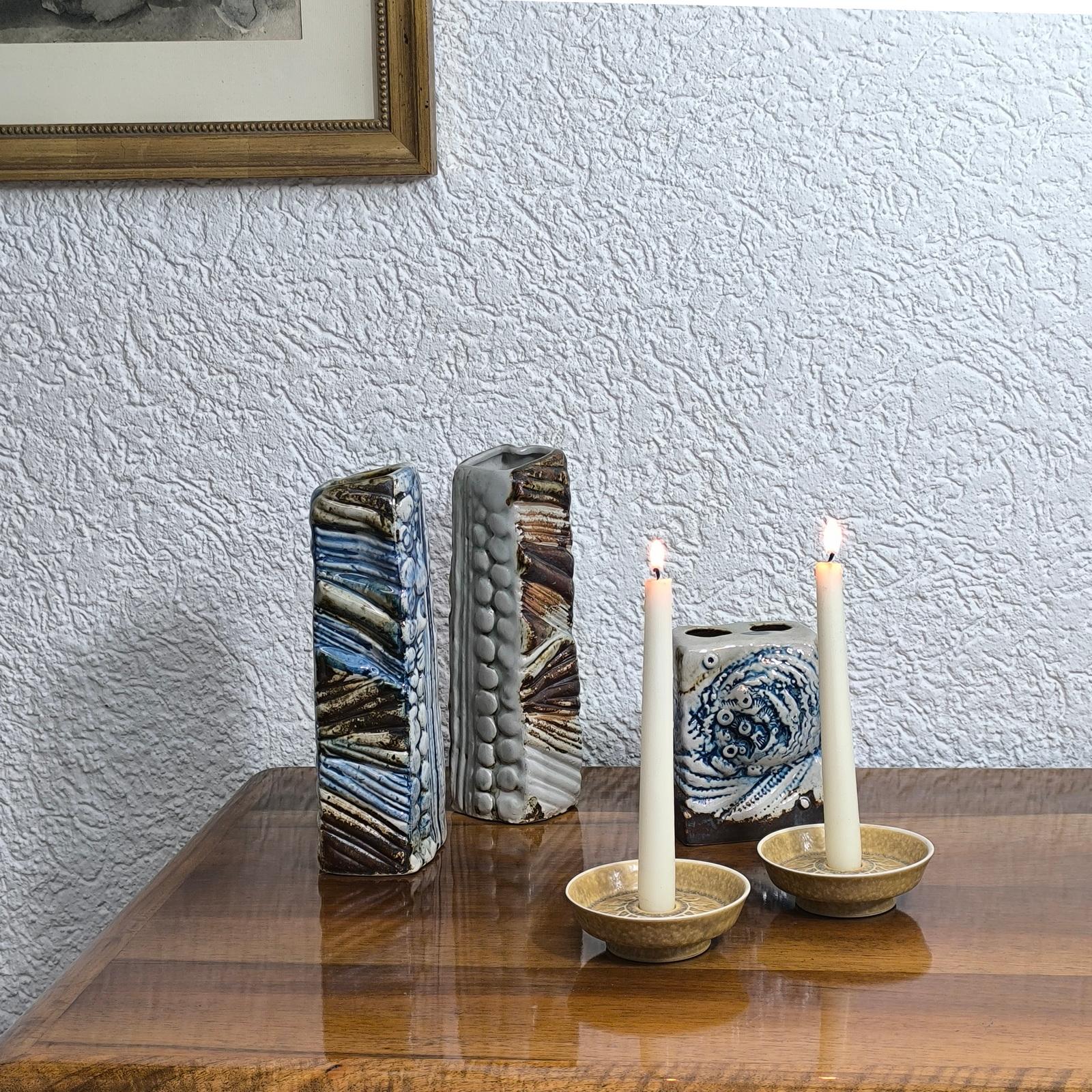 Danish stoneware candle holder from the Relief series, designed in 1959 by Jens Harald Quistgaard for Kronjyden. Original manufacturer label to the back. Excellent condition. Pieces of the Relief series are decorated with an embossed repeating