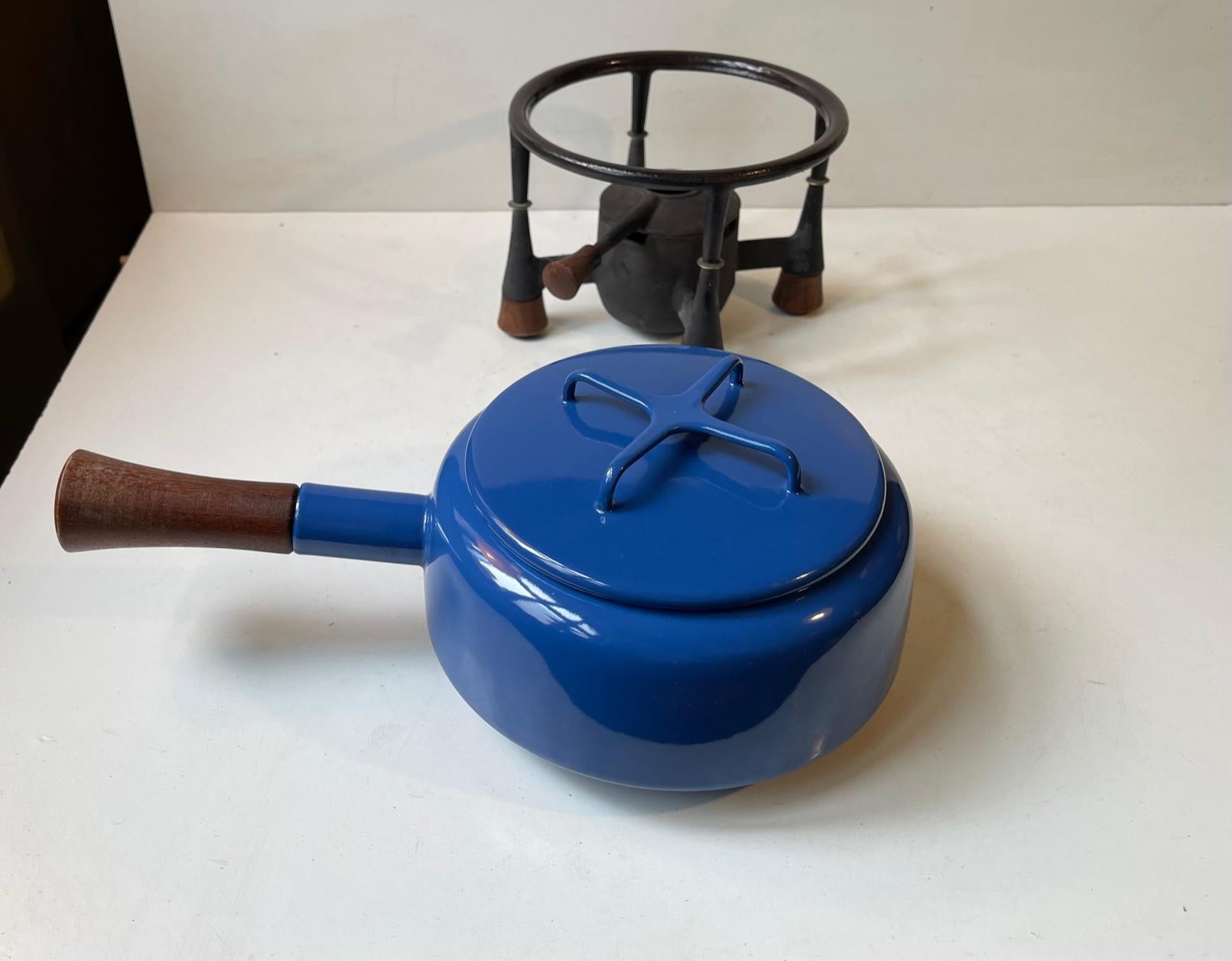 A very decorative and fully operational fondue set with Kobenstyle pot in blue and white enamel and stand/burner in cast iron with teak legs. The burner is to be used with regular cooking fuel or lamp oil. It was designed during the early 1960s by