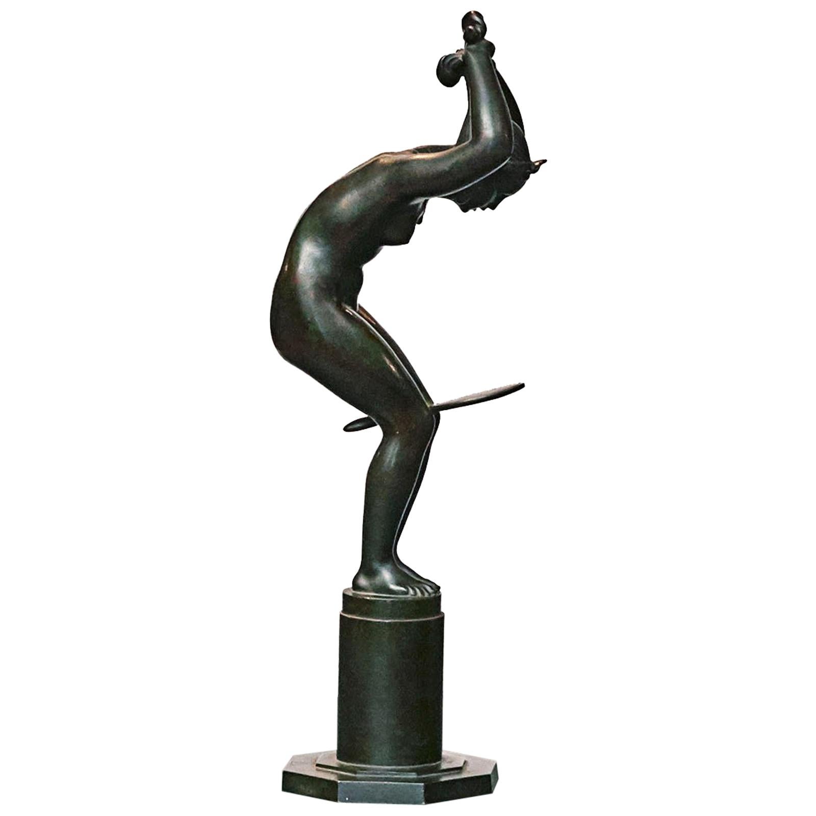 Jens Jacob Bregnø (1877-1946).
A dark patinated bronze sculpture of a nude woman braiding her hair while holding a mirror between her knees.
Signed with monogram to the base JJB.
On custom-made oak plinth.