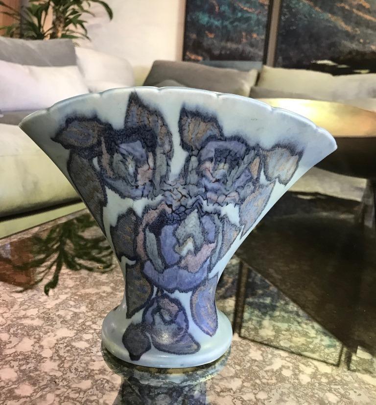 Stunning flower design with vivid, deep colors, this piece, a quite rare and hard to find shape, is by famed Danish-American artist Jens Jensen for the Rookwood Pottery Company.

Signed by Jensen and stamped/numbered (flame stamp) on the