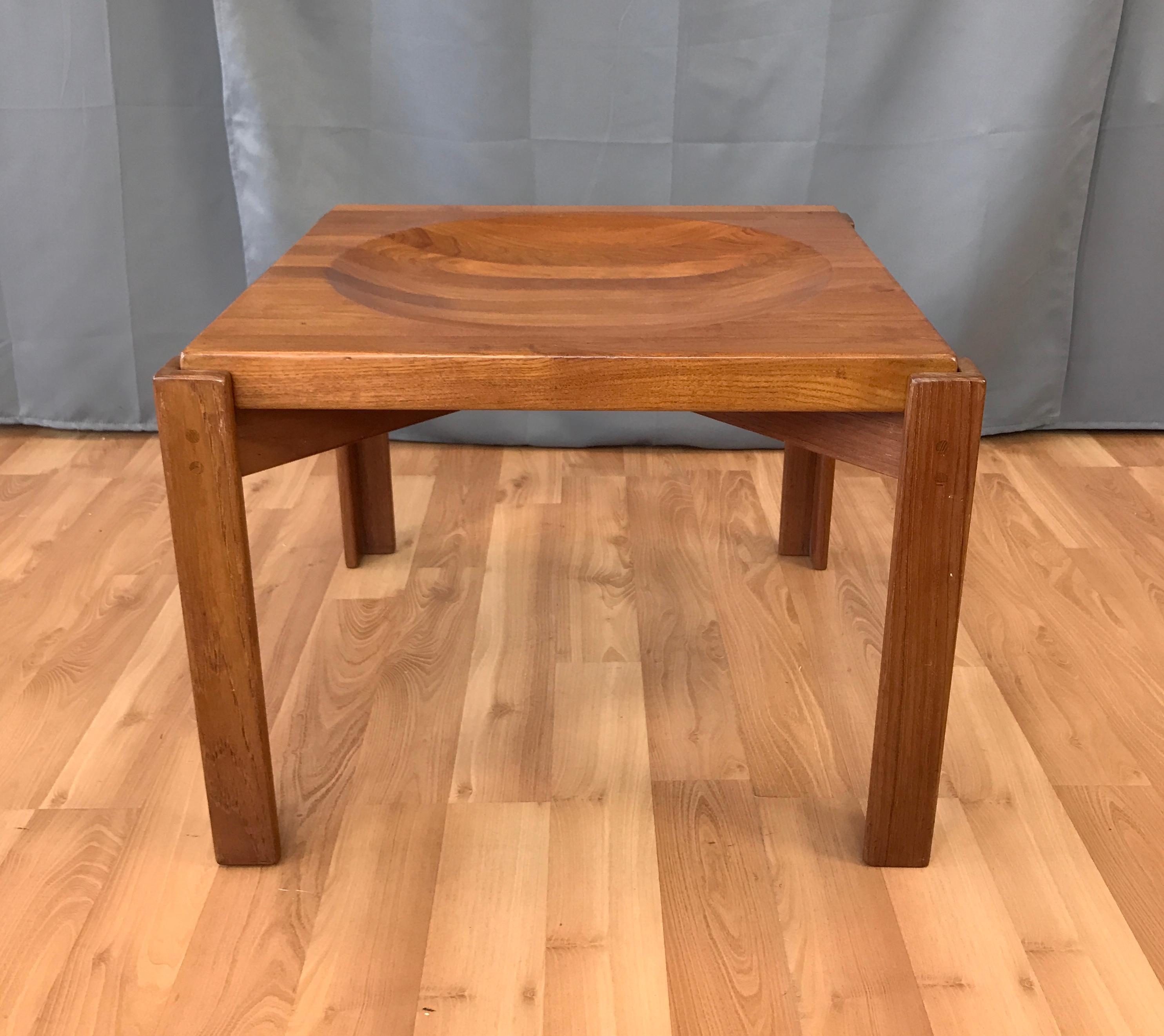 A solid Teak end table w/reversible butcher block top, it's been attributed to Jens Quistgaard. This one is unmarked, but we have seen them stamped made in Sweden.
When you flip the top over, from the flat side, you get the concave side.