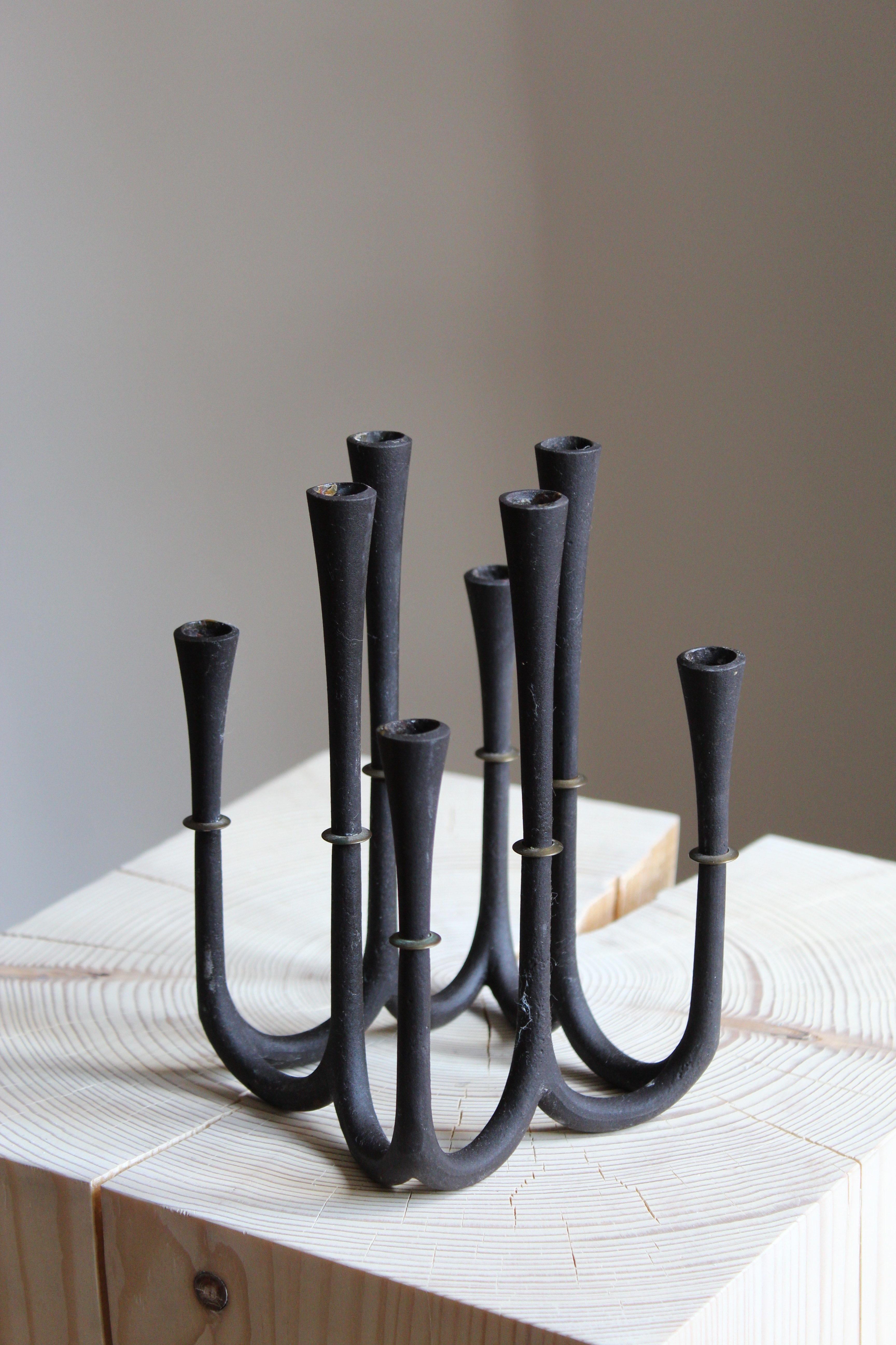 A sculptural candelabra designed and produced by Danish sculptor Jens Quistgaard. For small candles.