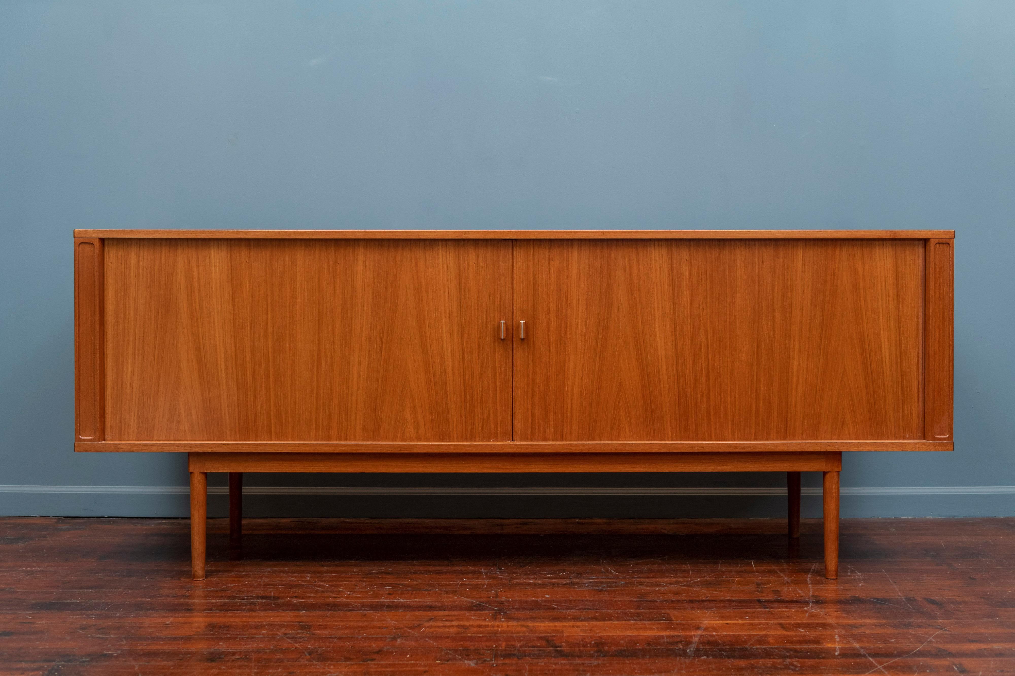 Jens Quistgaard design teak credenza for Peter Lovig Nielsen furniture, Denmark. Simple clean lines with tambor doors and a fitted adjustable interior. Newly refinished and ready to install.