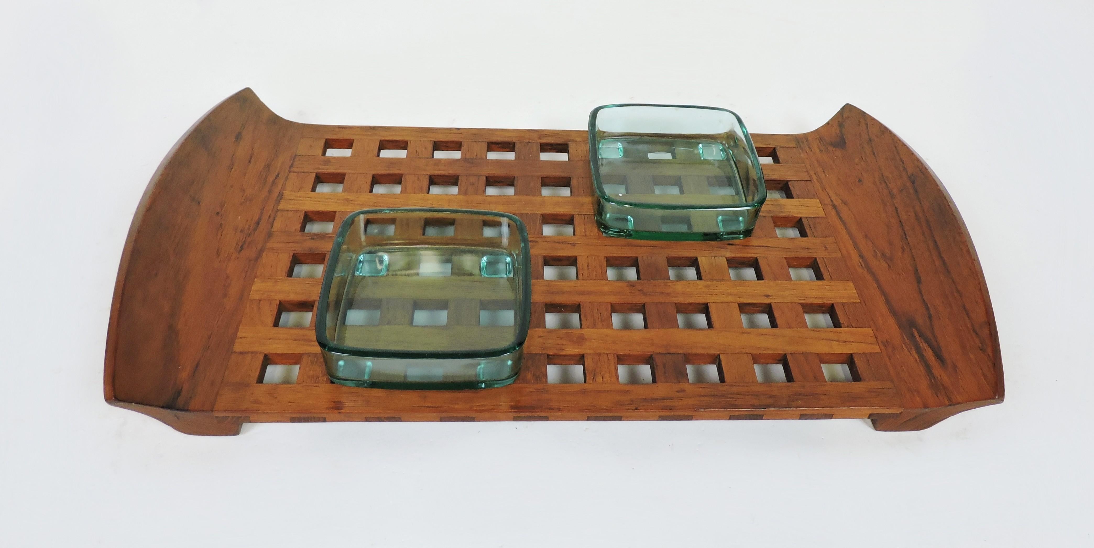 Lovely lattice teak tray with two blue glass inserts designed by Jens Quistgaard and made in Denmark by Dansk. The glass inserts are 4.25 inches square and have feet on the bottom that hold them in place. Stamped on bottom with Dansk logo. Could
