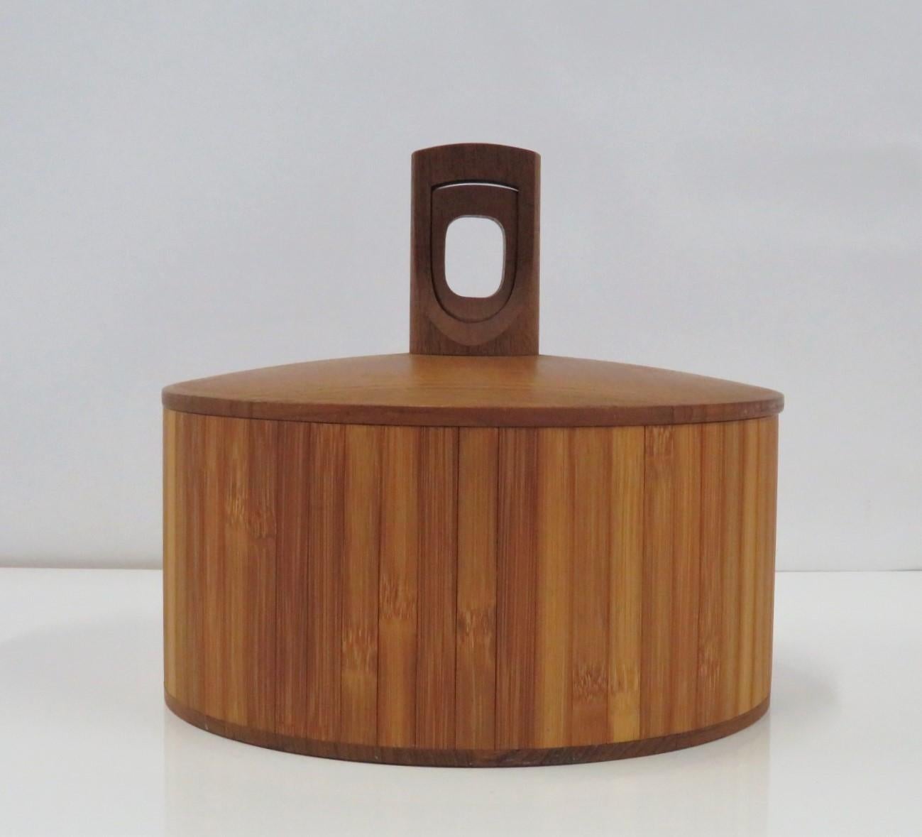 Seldom seen bamboo and teak ice bucket by Jens Quistgaard for Dansk from the Two Woods Series from early 1960s. The Two Woods ice buckets were made with the finest materials and an exquisite design by Jens Harald Quistgaard. This piece was with a