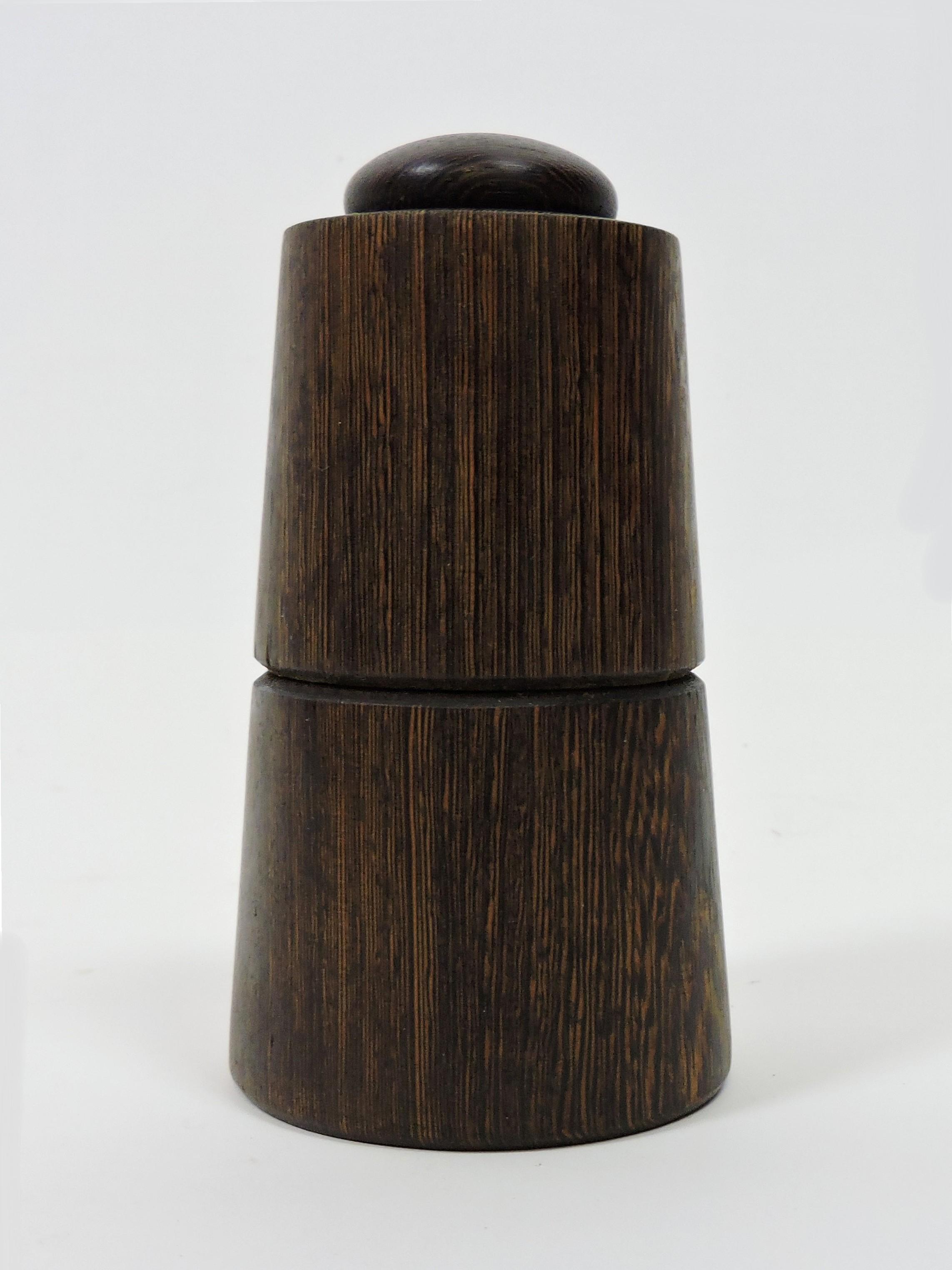 Rare model # 1607 combo salt shaker and peppermill designed by Jens Quistgaard and made in Denmark by Dansk. This is part of the rare woods series made of Wenge and has a Peugeot Freres grinder. There's a plug on the bottom to refill the pepper and