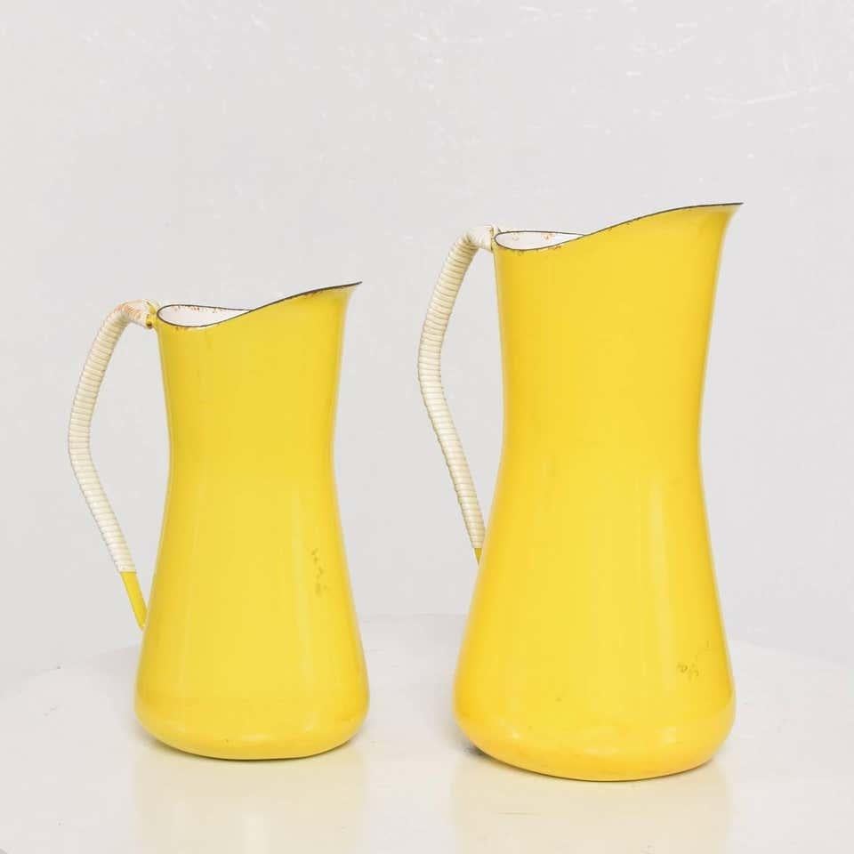 By Danish designer Jens Quistgaard for Dansk small pitcher in bright yellow enamel with white interior has plastic covered handles woven rattan look.
A Dansk Designs Denmark IHQ piece Mid-Century Modern 1960s stamped by maker. (we have a large