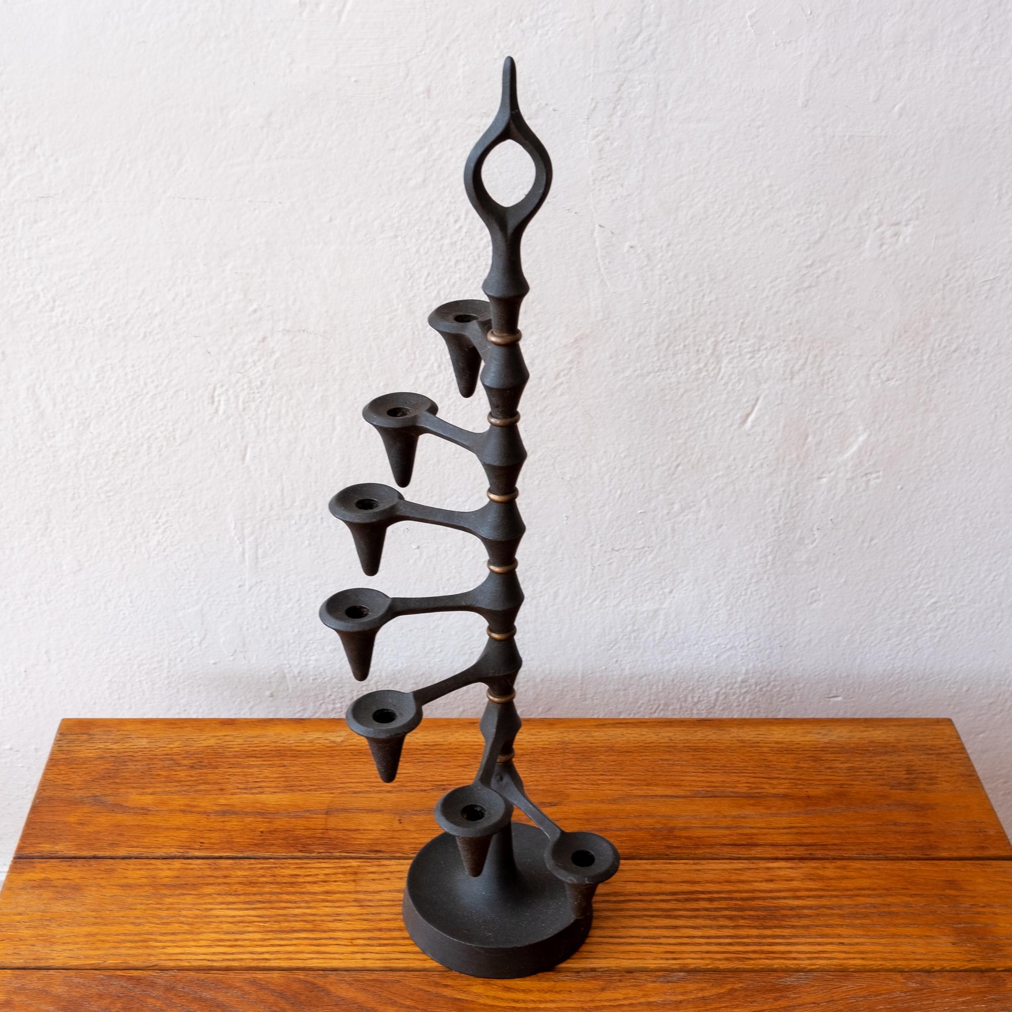Seven arm articulated candleholder designed by Jens Quistgaard for Dansk. Solid iron with brass
fittings. Each candle arm can swivel and is adjustable. Marked on the bottom. Modernist sculptural design from the midcentury. Made in Denmark.