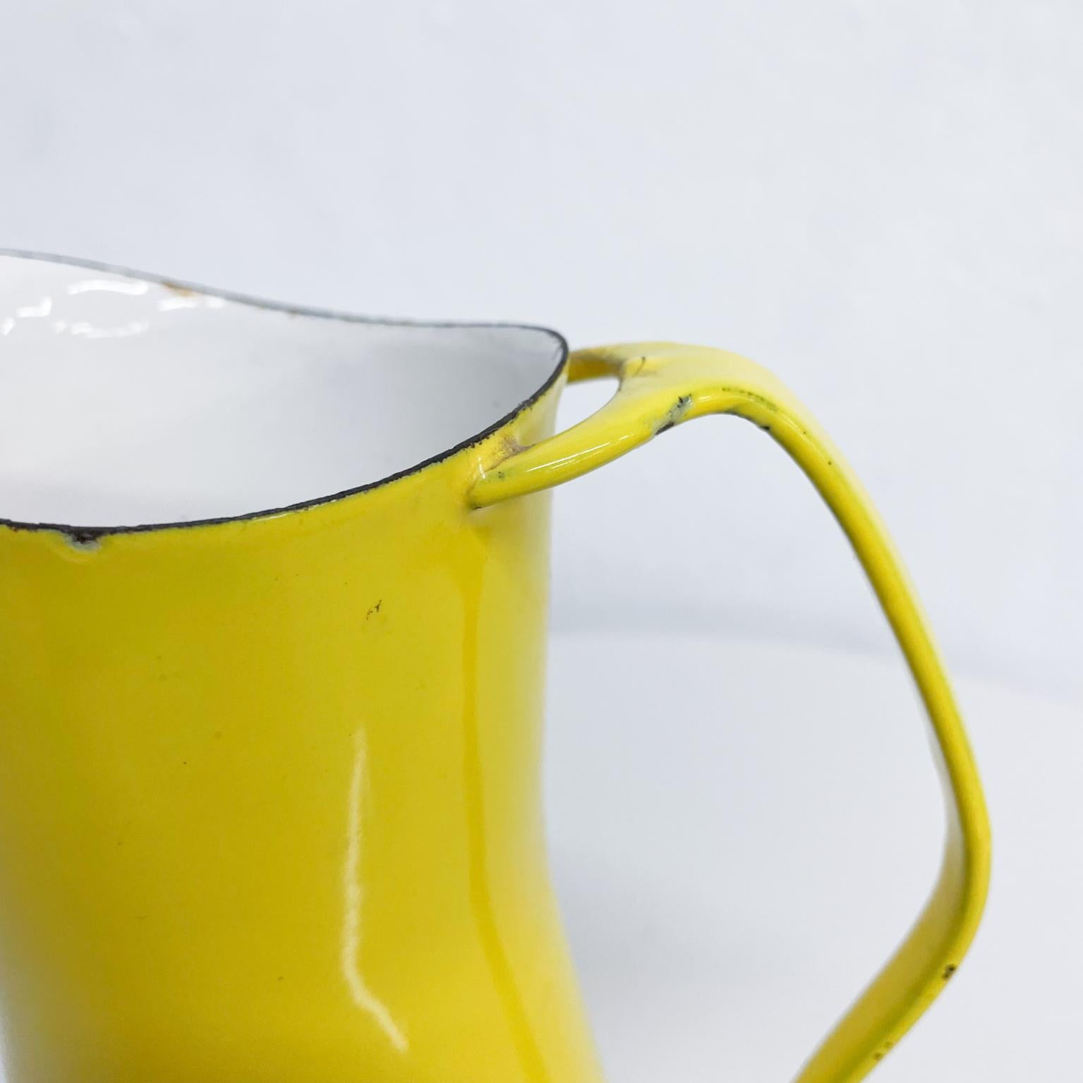 By Danish designer Jens Quistgaard for Dansk designs vintage pitcher in bright yellow enamel with white interior.
A Dansk Designs Denmark IHQ piece Mid-Century Modern 1960s
Dimensions: 8.25 tall x 5.5 depth x 4 in diameter.
Wear consistent with