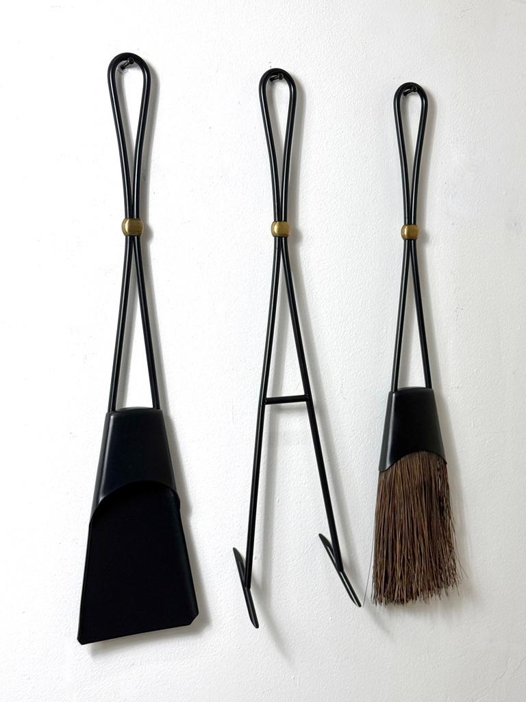 Rare set of fireplace tools designed by Jens Harald Quistgaard
Model 1400 for Dansk Denmark circa 1960

Newly restored iron shovel, broom and poker with looped handles and brass fittings 
Each signed with impressed markings

Dimensions as shown
24
