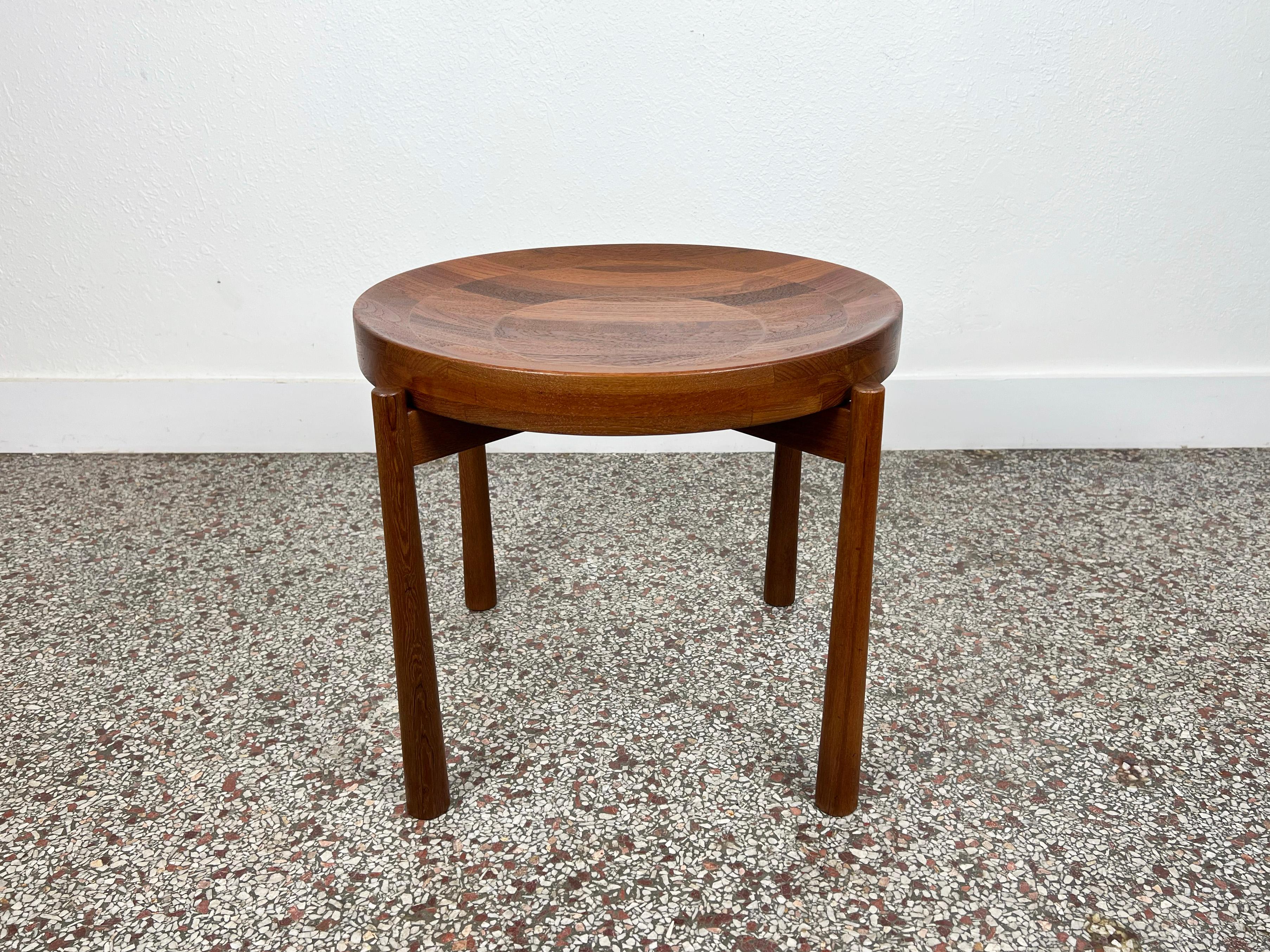 Vintage side table designed by Jens Quistgaard with a free-floating two-sided top crafted in solid teak. One side of the top provides a flat surface, while the other a bowl-shaped concave surface. 

Designer: Jens Quistgaard

Manufacturer: