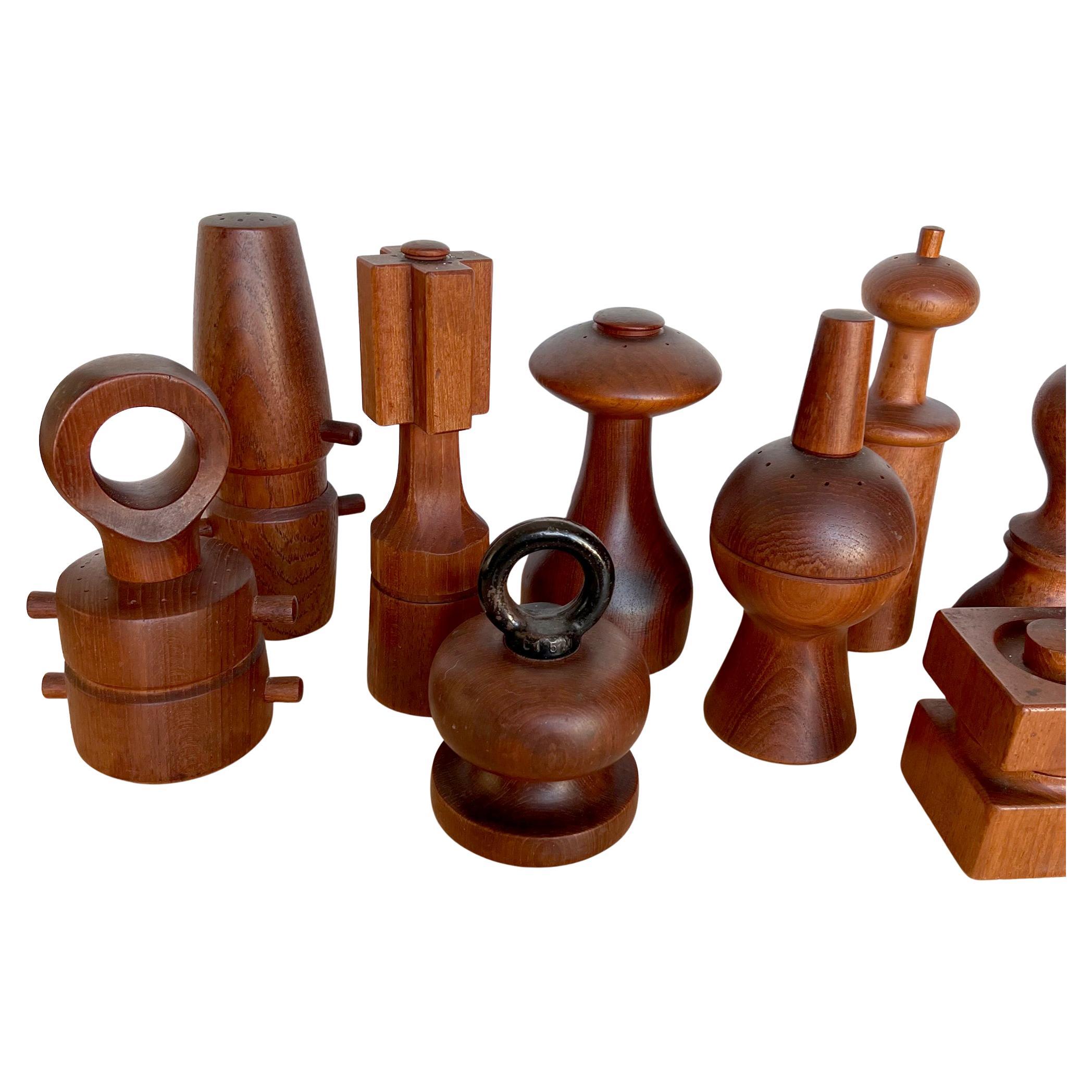 Lot of 10 Danish modern teak pepper mills by Dansk and one by Nissen with the black iron ring on top.  Varying in size and most with Puegeot grinders. Tallest being 8