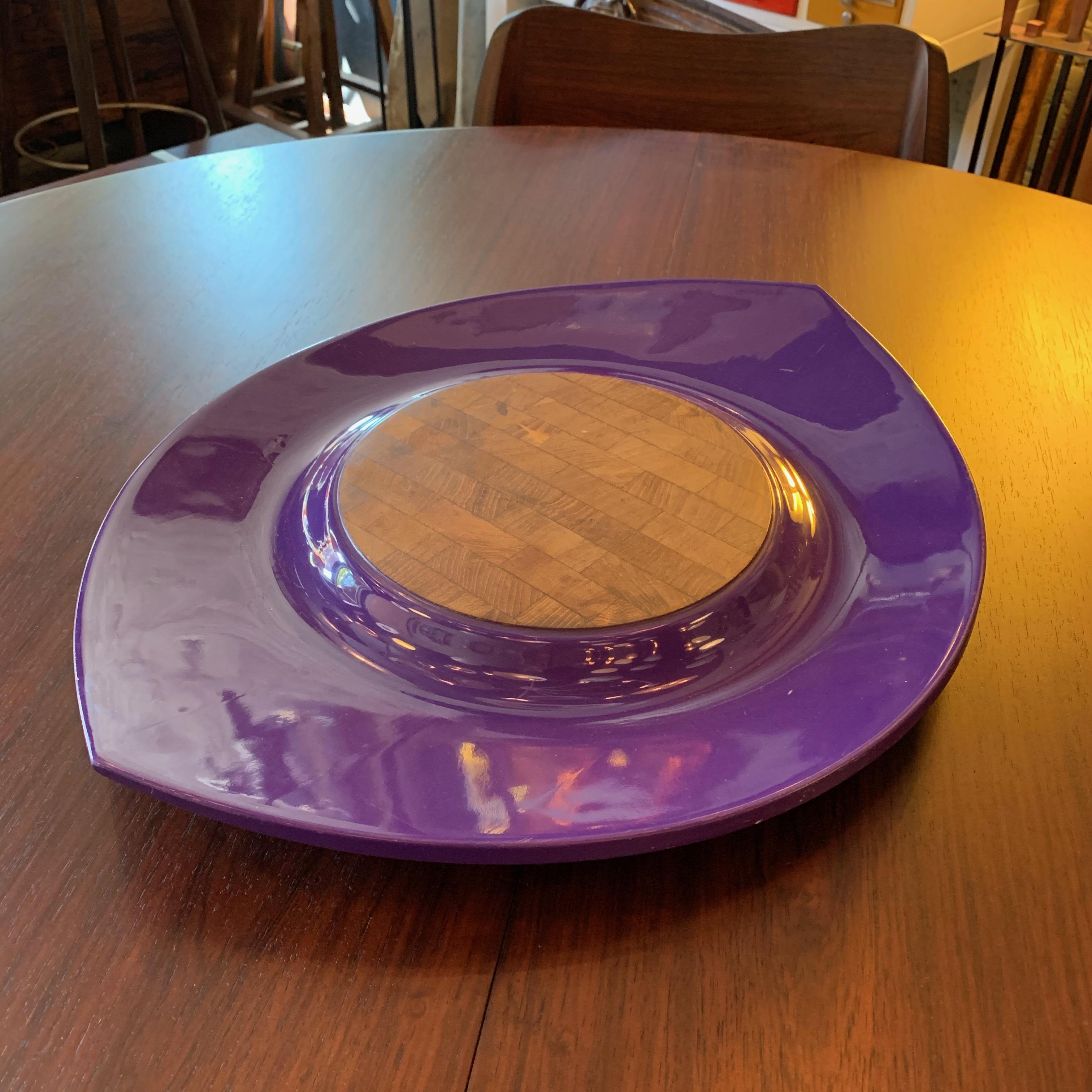 Brightly lacquered, Danish modern, oval serving tray with a raised teak cutting surface by Jens Quistgaard for Dansk with early Dansk mark.