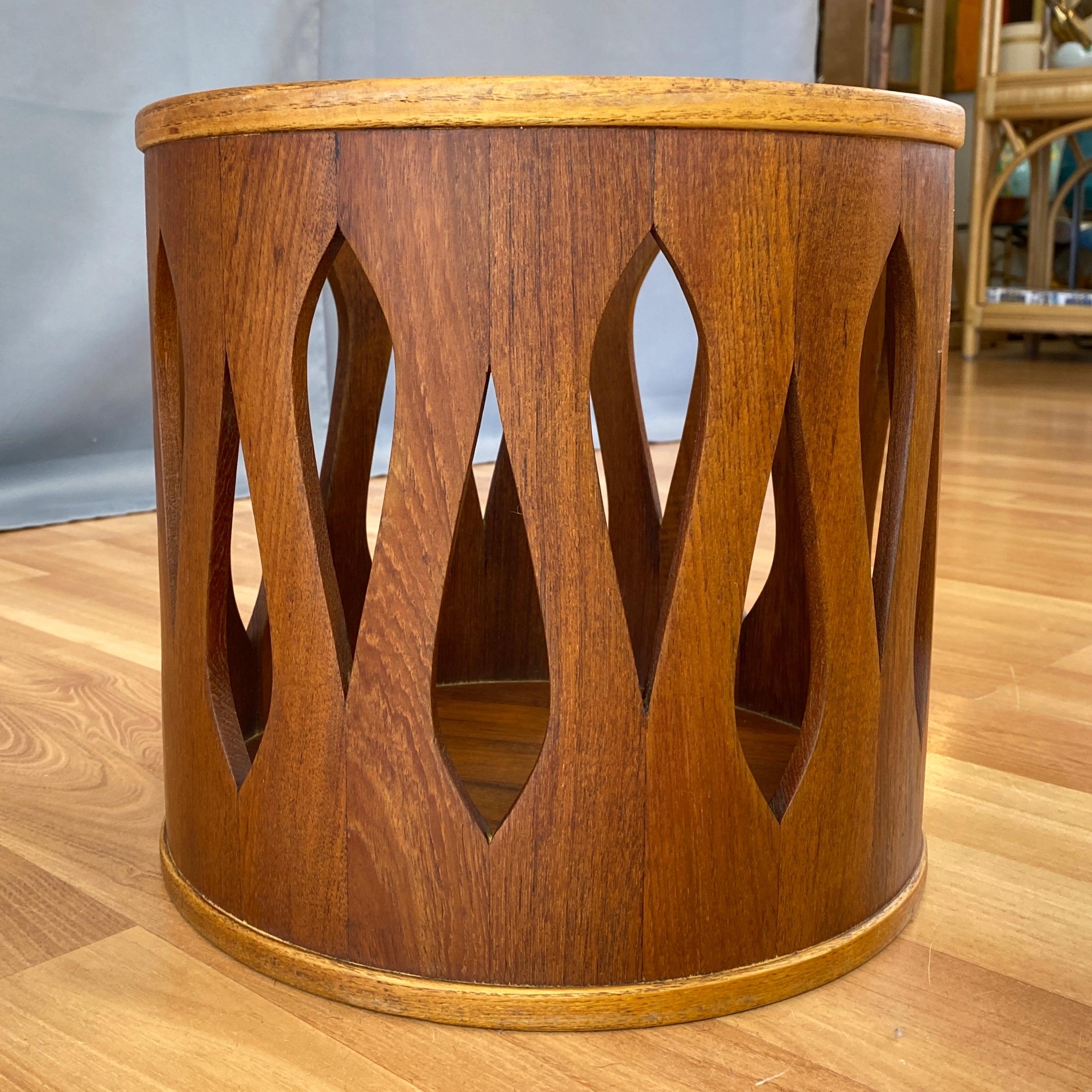 A fantastic late 1950s staved teak wastepaper basket, stool, or small table by Jens Quistgaard for Dansk from very early in his decades-long role as their chief designer.

Teak drum form with striking spearhead-shaped cut-out design. Contrasting