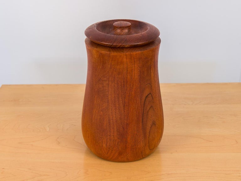 Curvy staved teak ice bucket by Jens Quistgaard for Dansk Designs. Black plastic liner. Stamped on the bottom with early maker's mark. Made in Denmark.