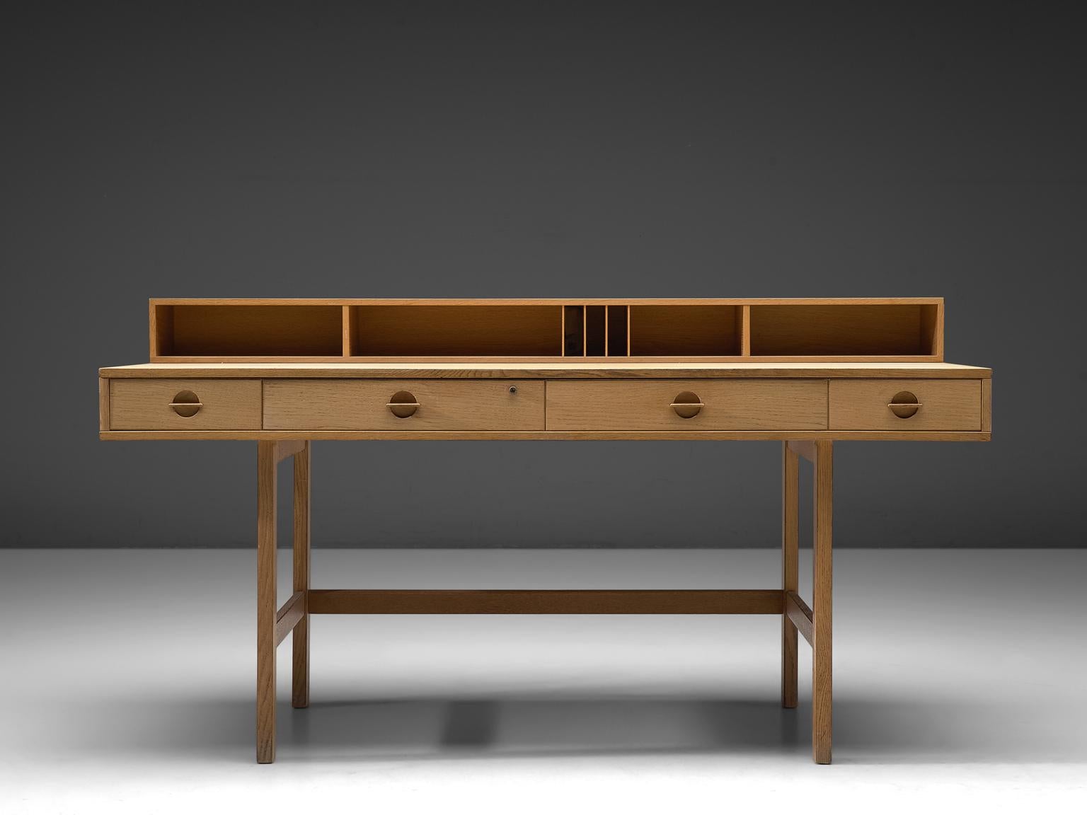 'Flip-top' desk by Jens Quistgaard for Peter Løvig Nielsen, oak, Denmark, 1960s. 

This secretary shelf and writing table has a storage element that can be flipped
down to extend the desk top for more working space instead. The front of the desk