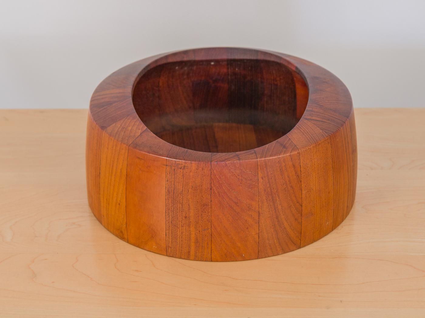 Early 1960s Danish modern teak bowl by Jens Quistgaard for Dansk. Staved wood grain panel and oval opening is wonderfully polished and attractive to admire. Early marking of Dansk Design Denmark IHQ on the underside.
