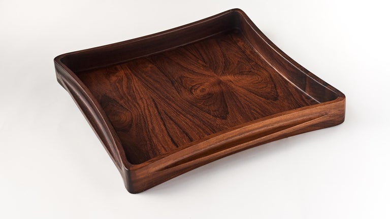 A sculptural high end tray, designed by infamous Danish sculptor and designer Jens Harald Quistgaard and manufactured by Dansk Design. Made of rosewood, this tray is showing an outstanding woodwork, from the very precise corner joints, to it’s