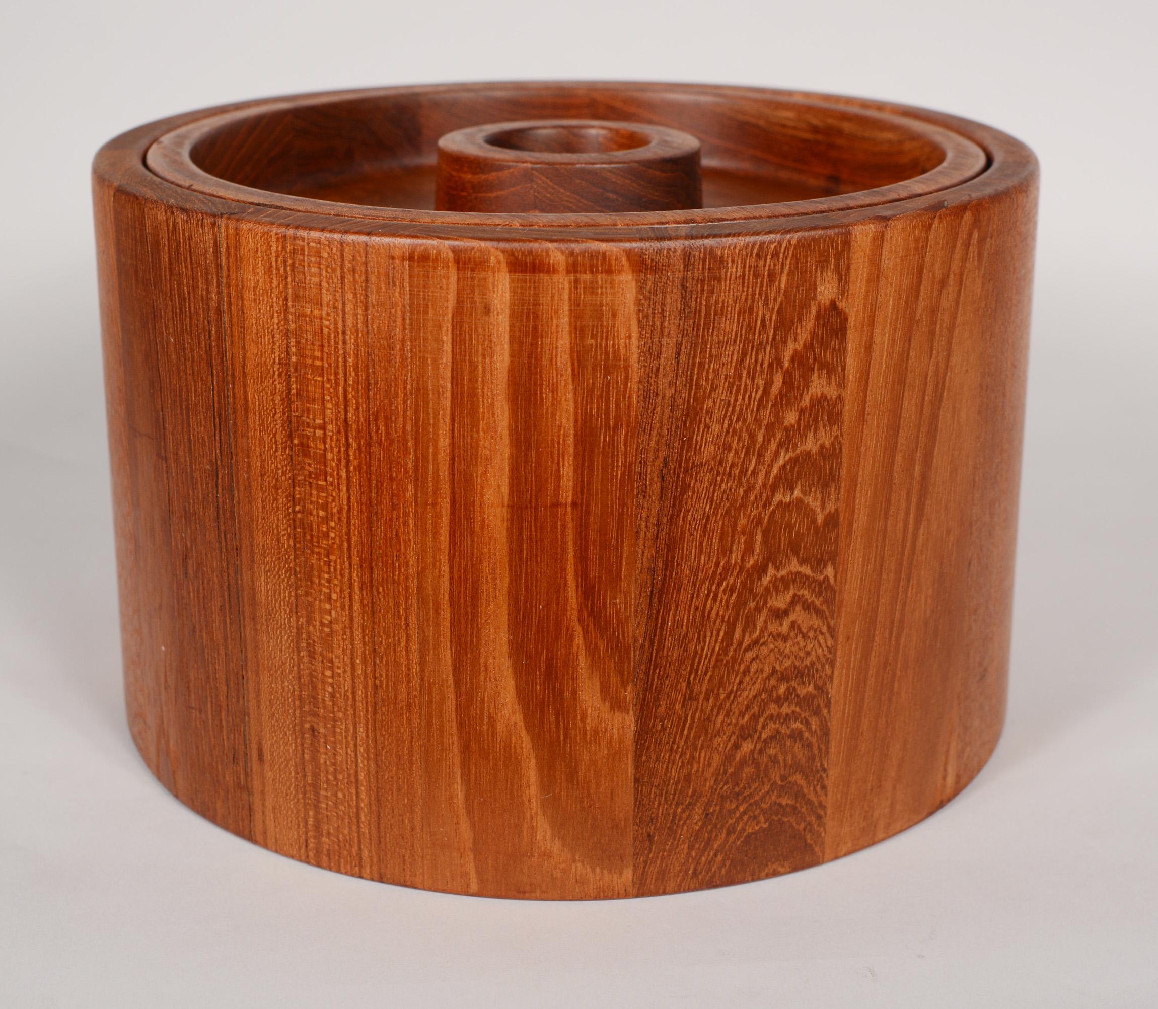 Staved teak ice bucket designed by Jens Quistgaard for Dansk Designs. This ice bucket is slightly tapered and has a recessed lid.