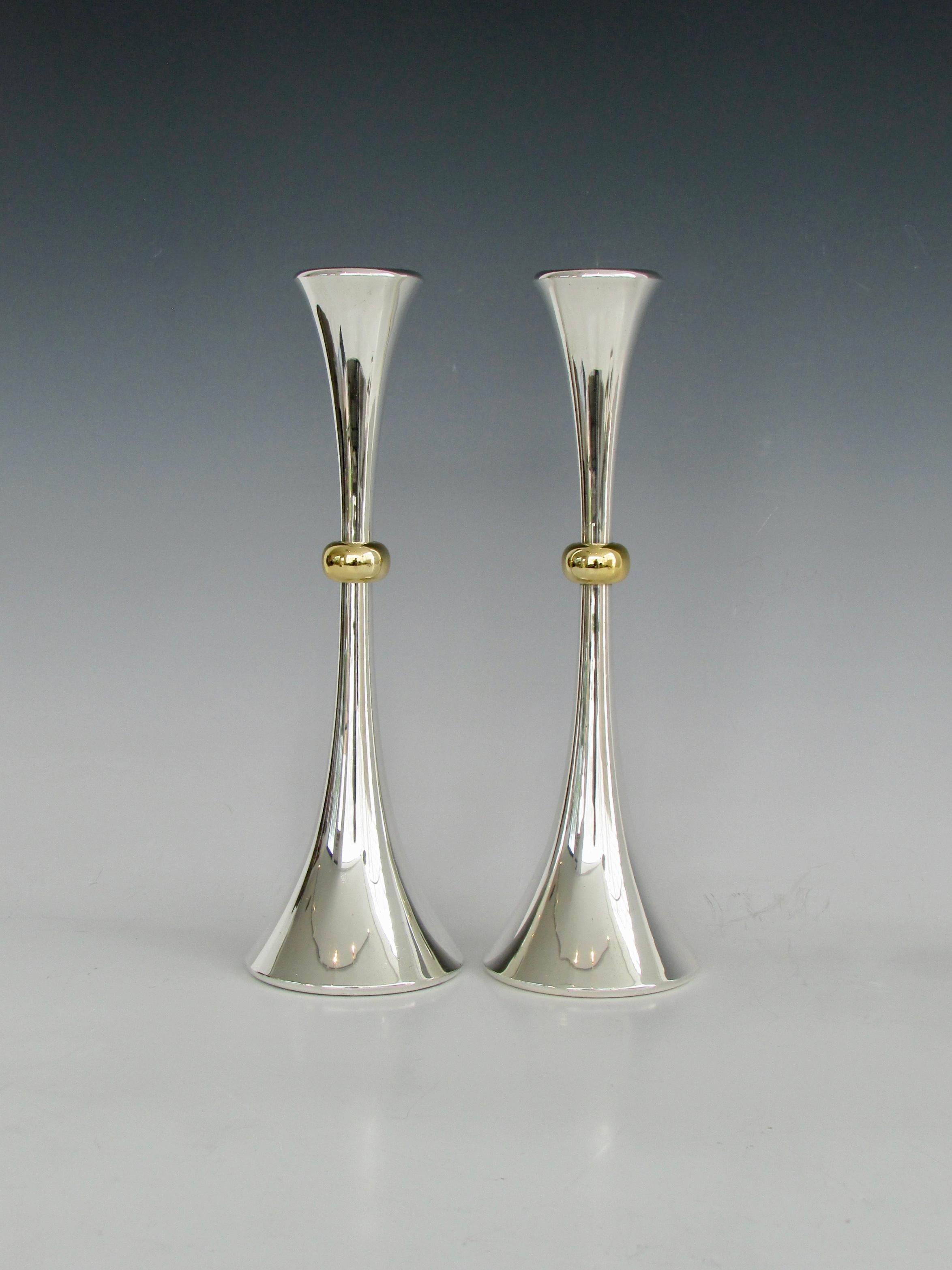 A modernist trumpet shaped candlestick pair designed by Jens Quistgaard for Dansk Designs in silver plate with a brass collar. Dansk Designs JHQ Japan labels on underside. Good condition.