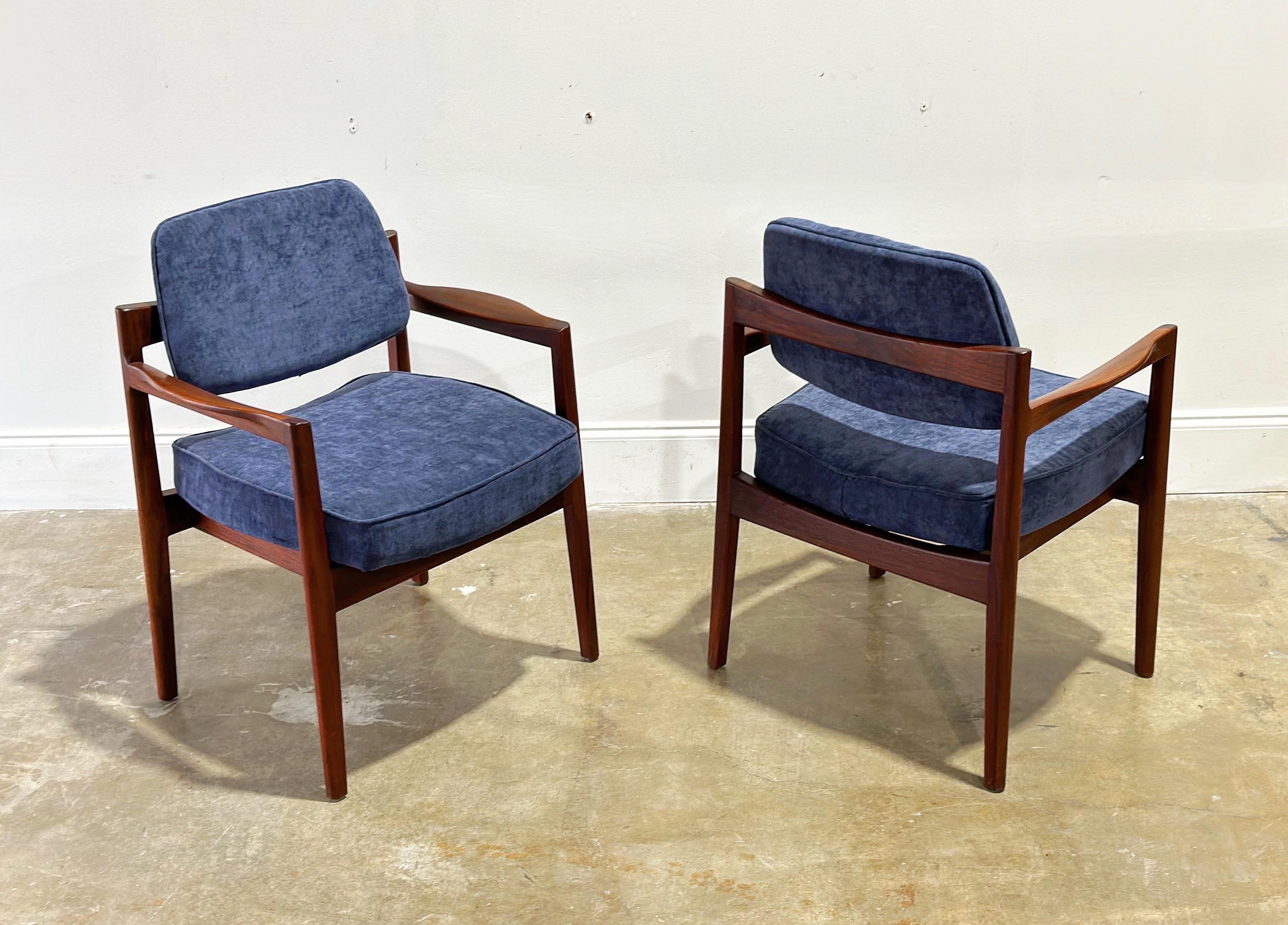 Jens Risom upholstered arm chairs in sculpted solid black walnut - set of two, circa early 1960s. Refined, elegant Danish modern design coupled with stout and sturdy American craftsmanship.

This listing is for a pair (2) arm chairs - We have