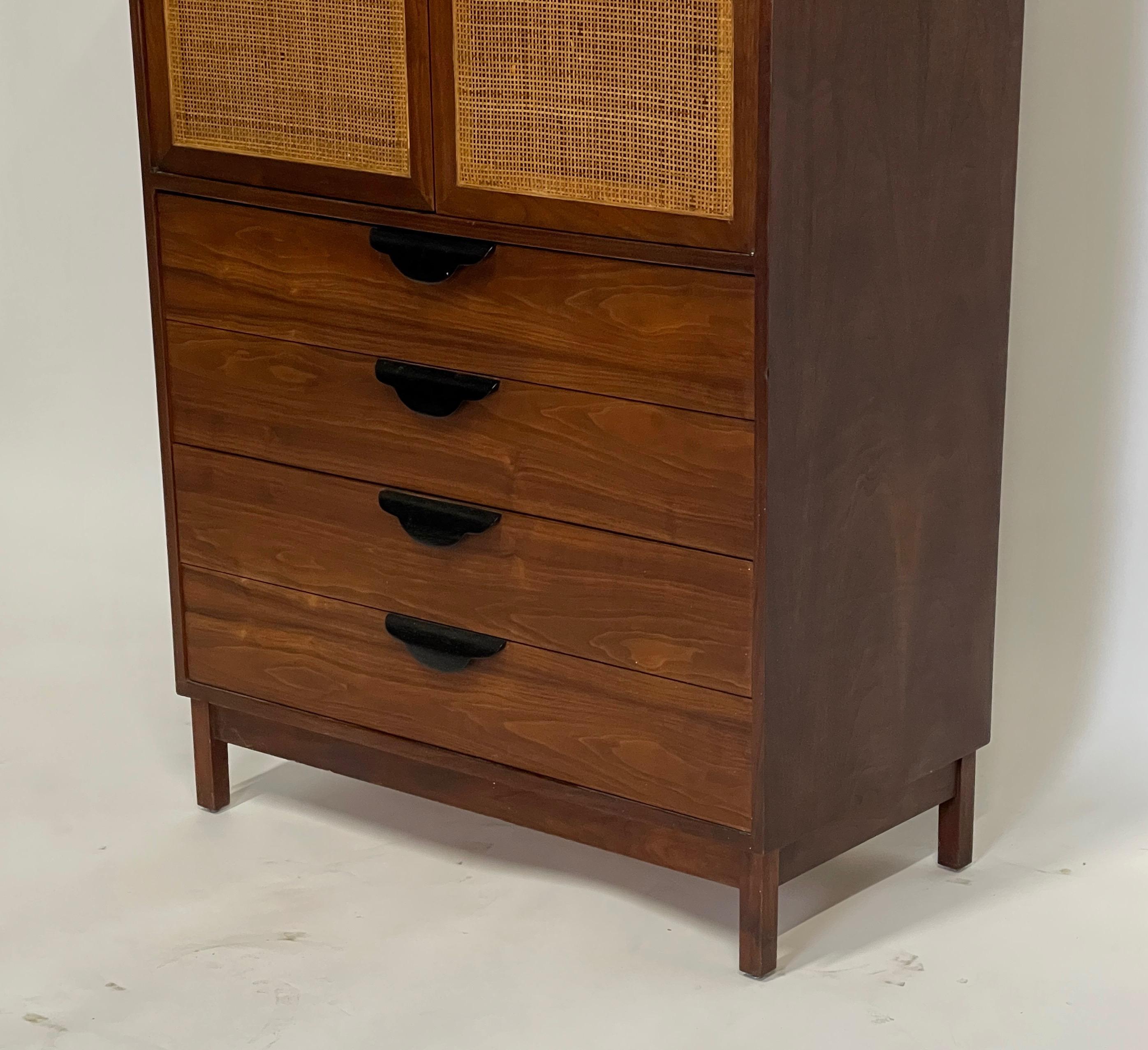 Stunning tall Jens Risom attributed highboy with ebonized oak pulls and woven cane doors.