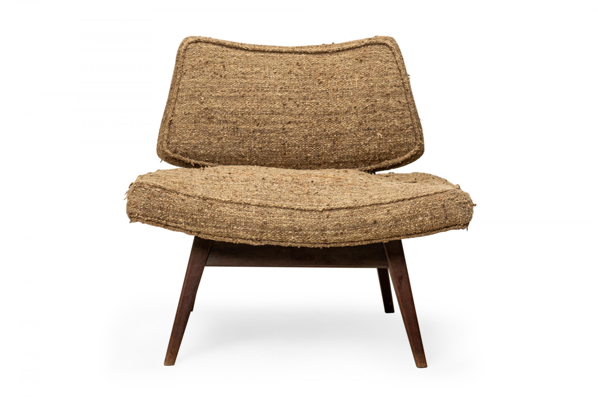 Danish mid-century slipper / side chair with a wide curved seat cushion and smaller low back cushion, upholstered in a beige and brown textured fabric, resting on a teak base with square angled and tapered legs. (JENS RISOM)
 
