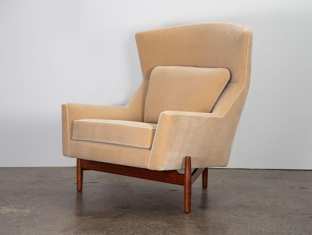 An original Model 2117 Chair, designed by Jens Risom for his company Jens Risom Design Inc. Beautifully restored in plush Knoll mohair velvet. Angular lines of the lounge chair contrast nicely with the oversized round ottoman. Lovely walnut wood