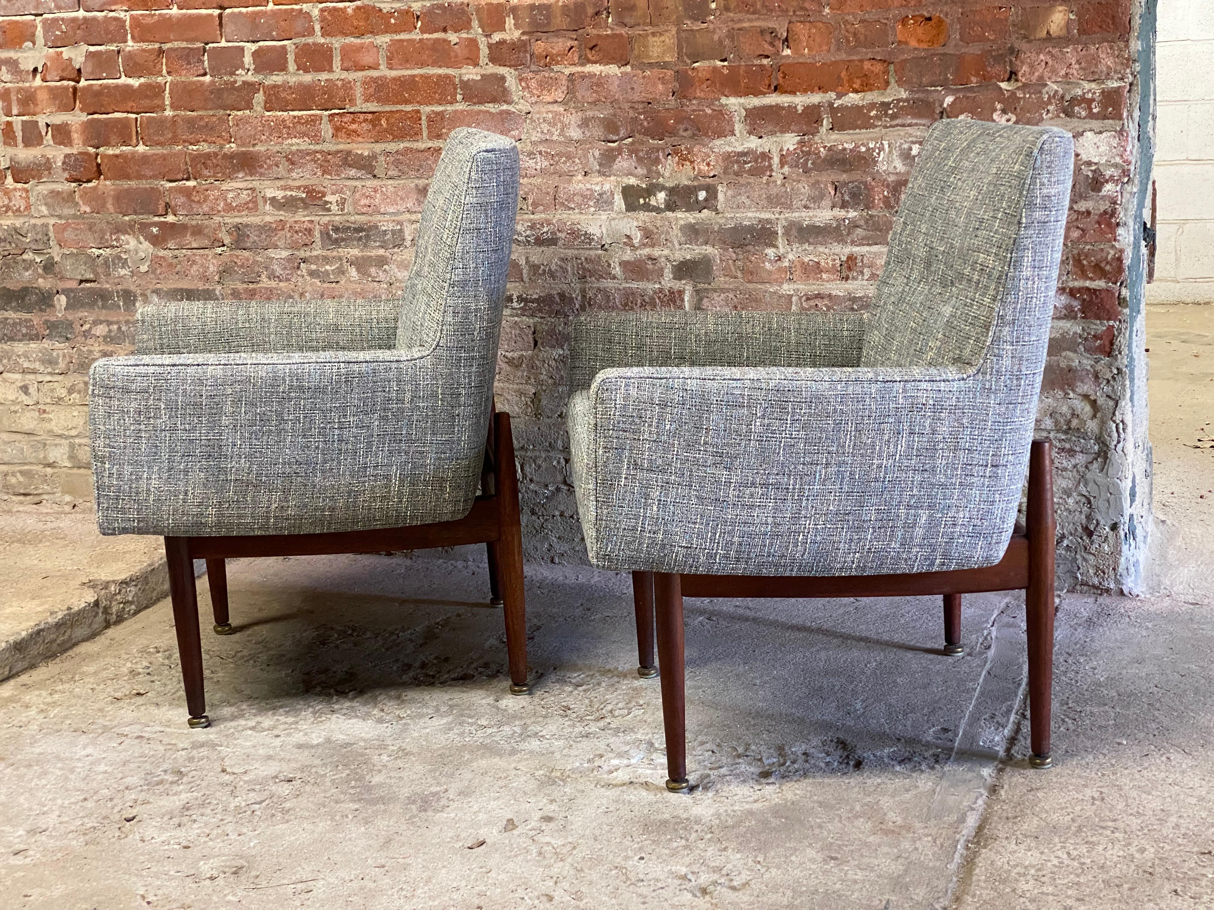 An excellent pair of Jens Risom designed C180 upholstered and walnut armchairs. Also know as 1109 after 1961. Risom was an instrumental part of revolutionizing the look of American living rooms and corporate offices. He paid homage to the beauty of