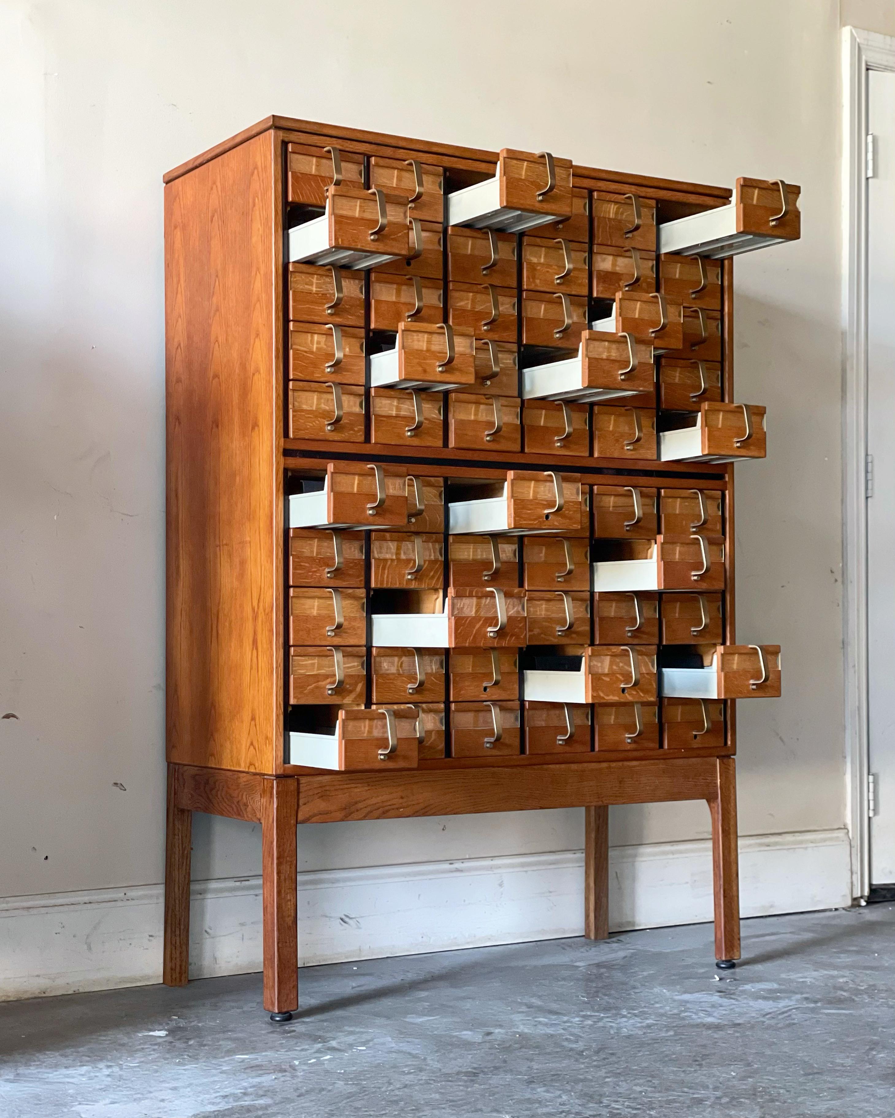 Rare Mid-Century Modern library card catalog in quarter sawn oak and solid brass by Jens Risom. Unique on the market - truly a collectors piece. 60 drawers, each one embossed with the Risom logo. Stunning 3/4