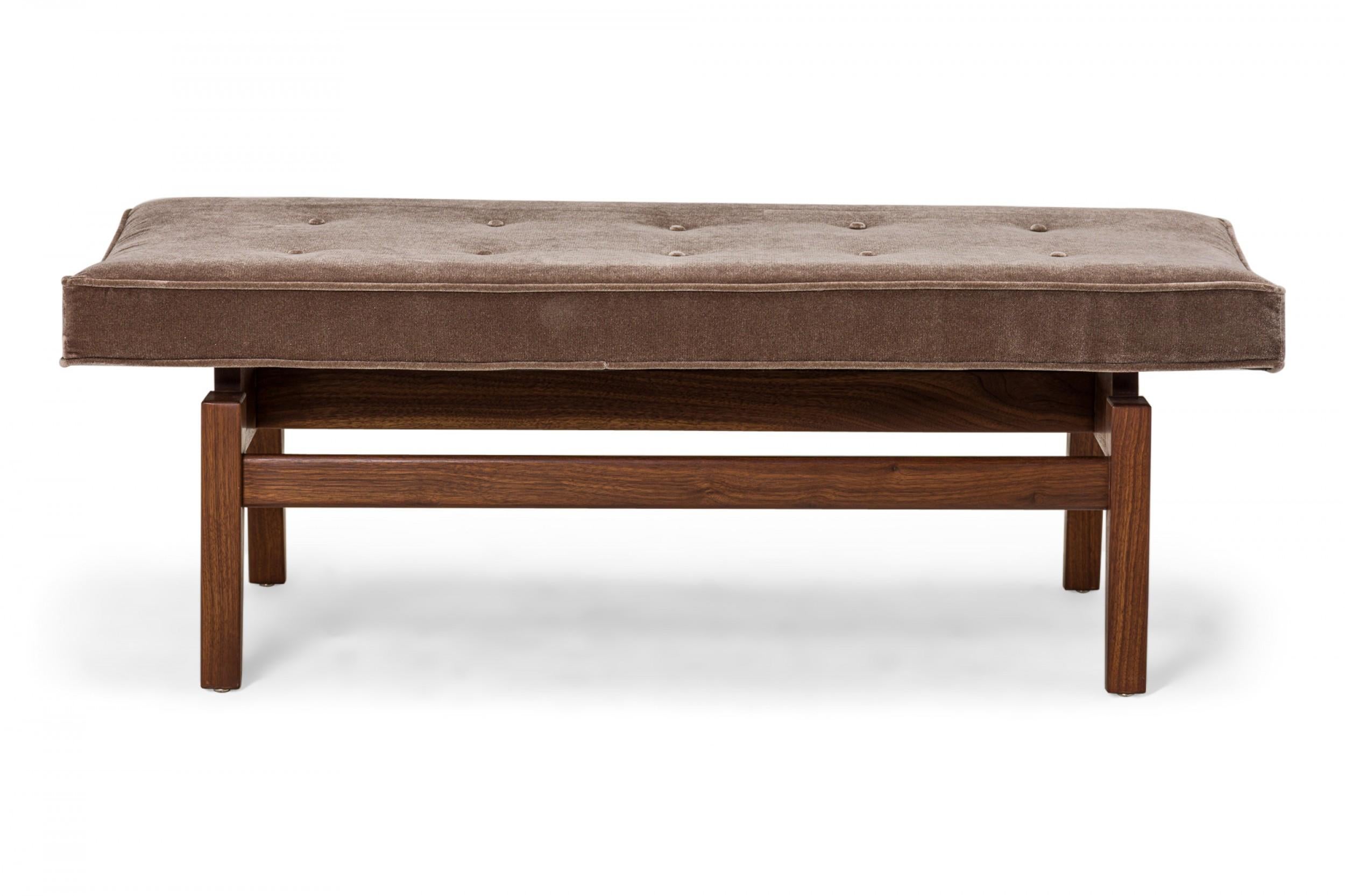 Danish Mid-Century floating bench with a walnut stretcher base supporting a rectangular seat cushion upholstered in gray velvet with button tufted detail. (JENS RISOM).
 