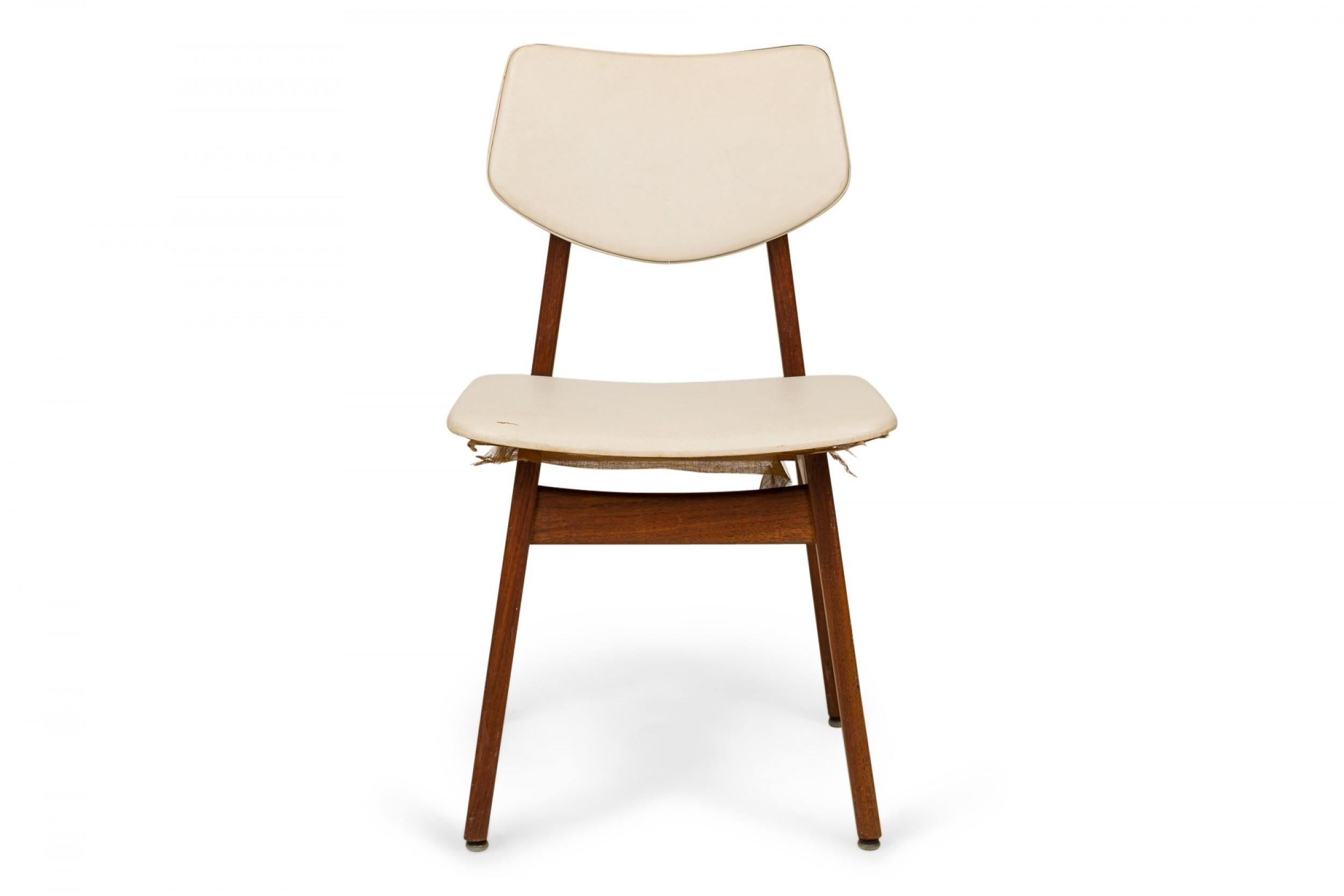 Danish Mid-Century dining side chair with a teak wood frame and off-white vinyl upholstered seat and chair back. (JENS RISOM)
